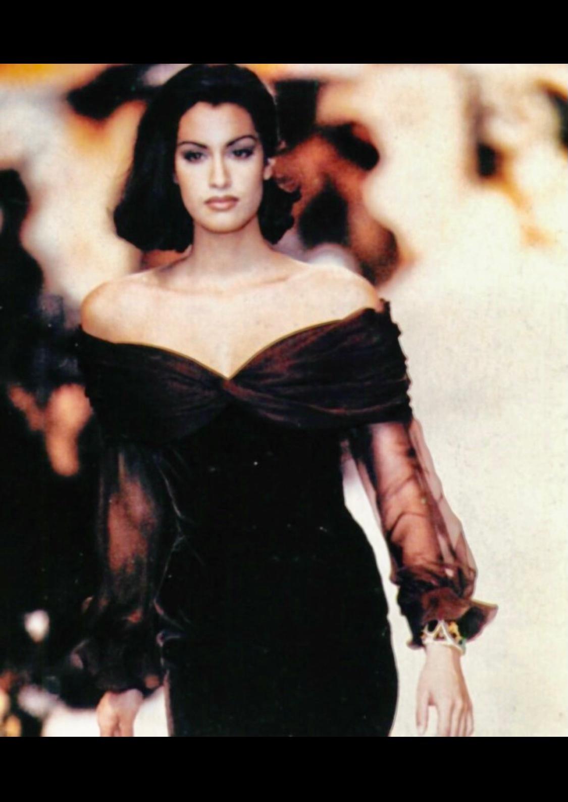 TheRealList presents: a chocolate brown velvet and sheer Valentino Garavani dress. From the Fall/Winter 1991 collection, this chic and sexy dress debuted on the season's runway modeled by Yasmeen Ghauri. This stunning dress features a form-fitting