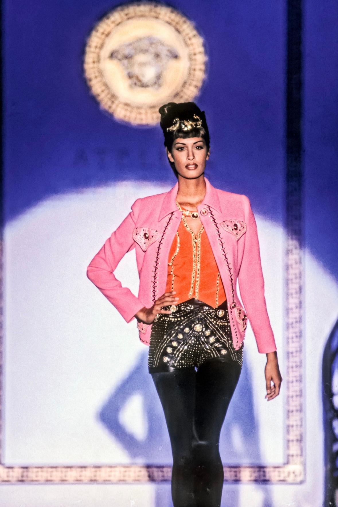 Presenting an incredible pair of black studded Atelier Versace mini shorts, designed by Gianni Versace. From the Fall/Winter 1992 'Miss S&M' season, these mini high-waisted shorts debuted on the season's couture runway on Yasmeen Ghauri. These