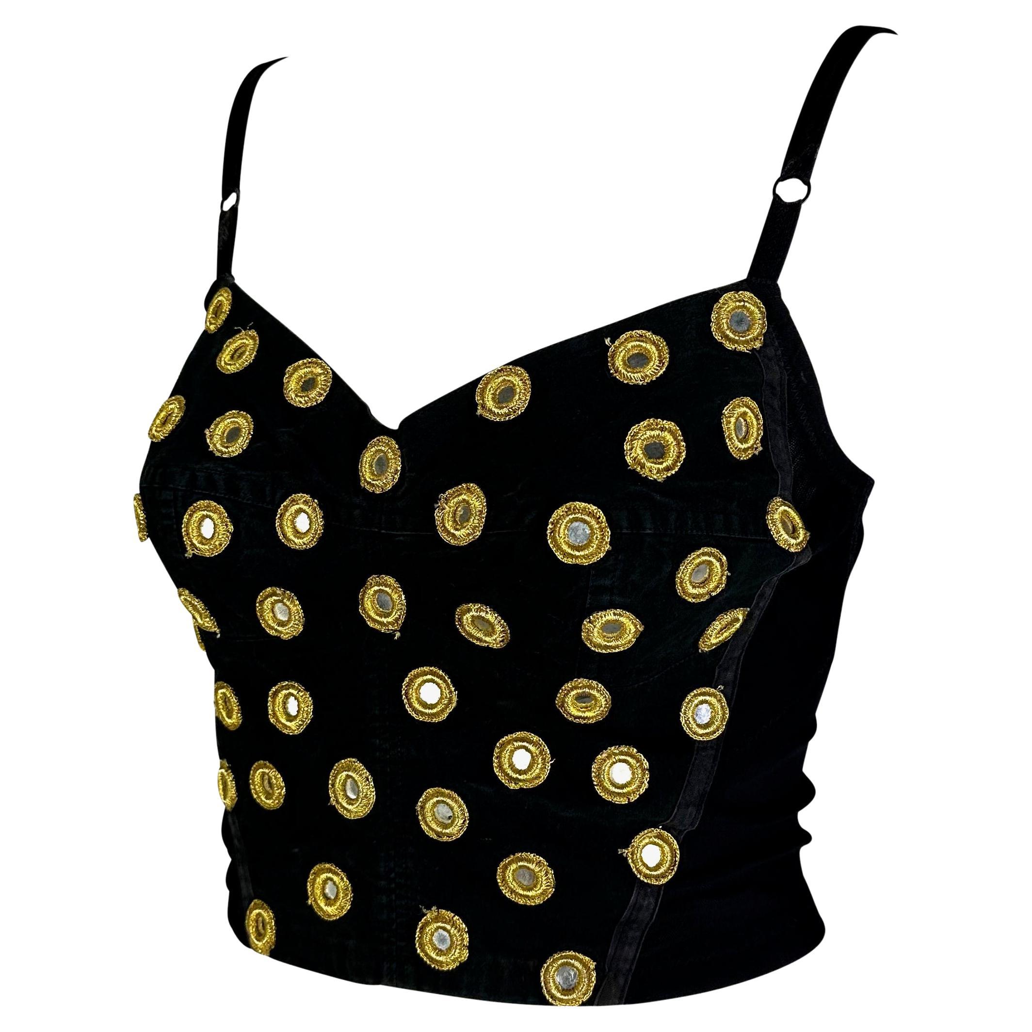 Presenting a beautiful black Dolce and Gabbana crop top. From the Fall/Winter 1992 collection, this incredible crop top features a sweetheart neckline and spaghetti straps. The front of this top is covered in silver mirrors surrounded by yellow
