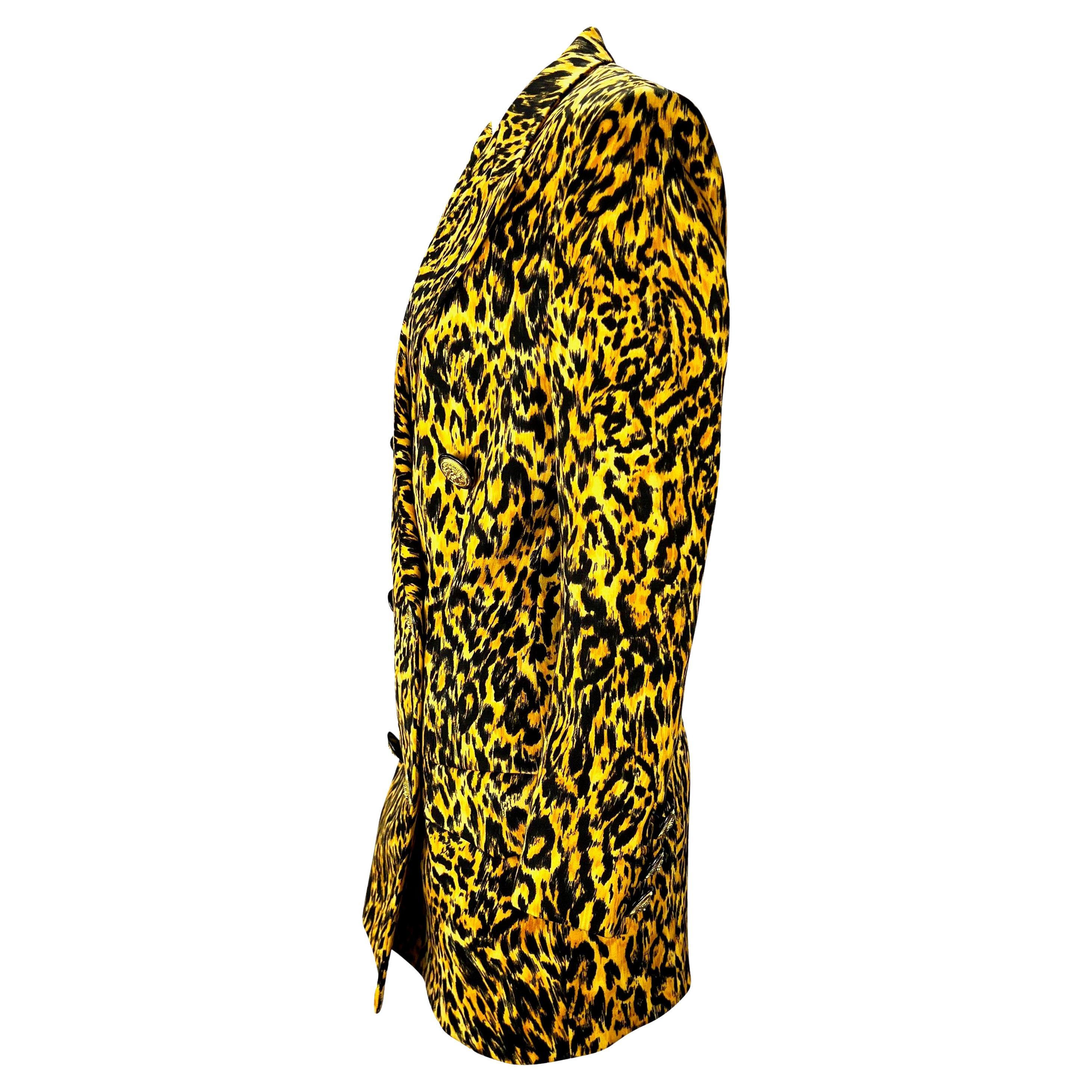 Presenting a cheetah print double-breasted Gianni Versace Couture blazer, designed by Gianni Versace. From the Fall/Winter 1992 collection, this fabulous blazer features gold Roman-inspired coin buttons at the front closure and cuffs, a long body,