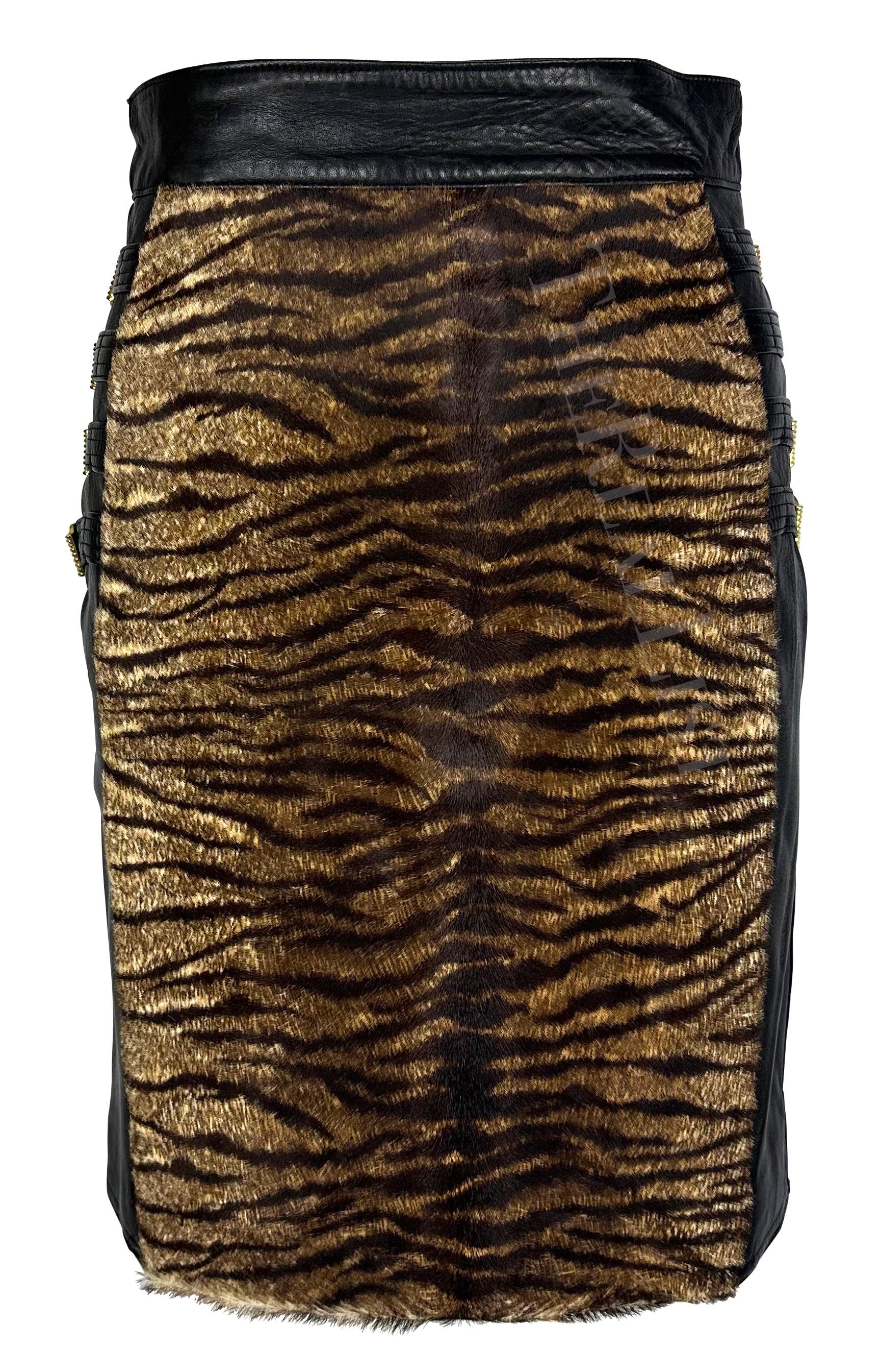 Presenting a fabulous black leather and pony hair Gianni Versace skirt, designed by Gianni Versace. From the Fall/Winter 1992 'Miss S&M' collection,  this skirt is constructed of black leather with a tiger print pony hair panel at the front. This