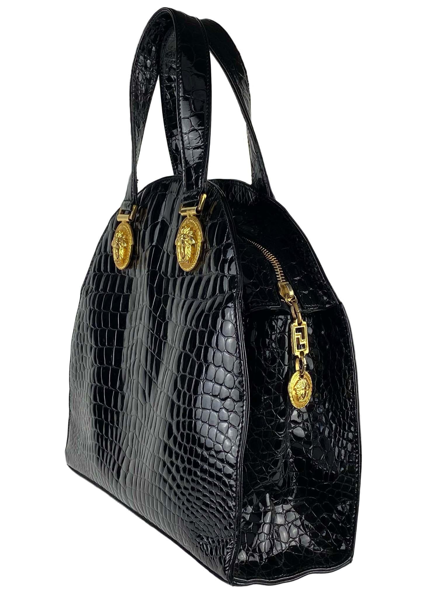 Presenting an embossed patent leather dome bag by Gianni Versace. This piece was released as part of Versace's iconic 'Miss S&M' F/W 1992 collection, famous for its bondage-inspired designs. Truly a power bag, this piece is sure to turn heads with