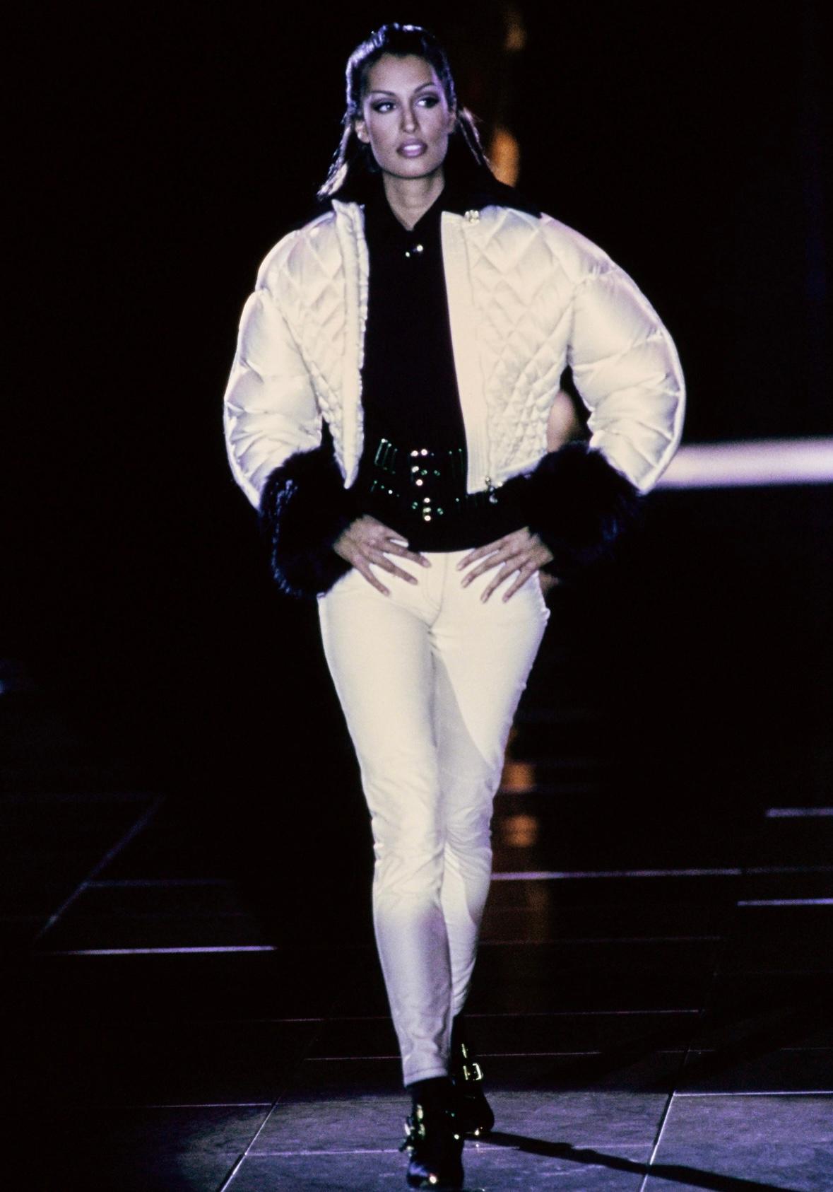 Presenting a gorgeous black Gianni Versace bondage-inspired blazer, designed by Gianni Versace. From the Fall/Winter 1992 'Miss S&M' collection, this chic blazer debuted as part of look 23 on Yasmeen Ghauri. Leather straps with large gold-tone