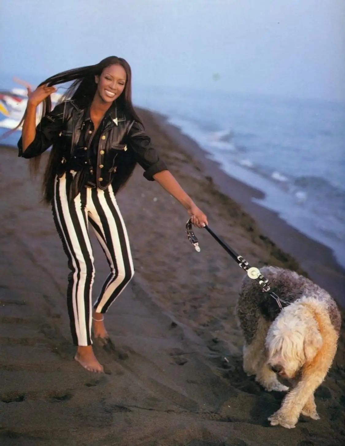 From the Fall/Winter 1992 'Miss S&M' collection, this black leather Gianni Versace belt debuted on the season's runway as part of look 41, modeled by Nadège du Bospertus. This chic belt was also used as a dog leash held by Naomi Campbell in an