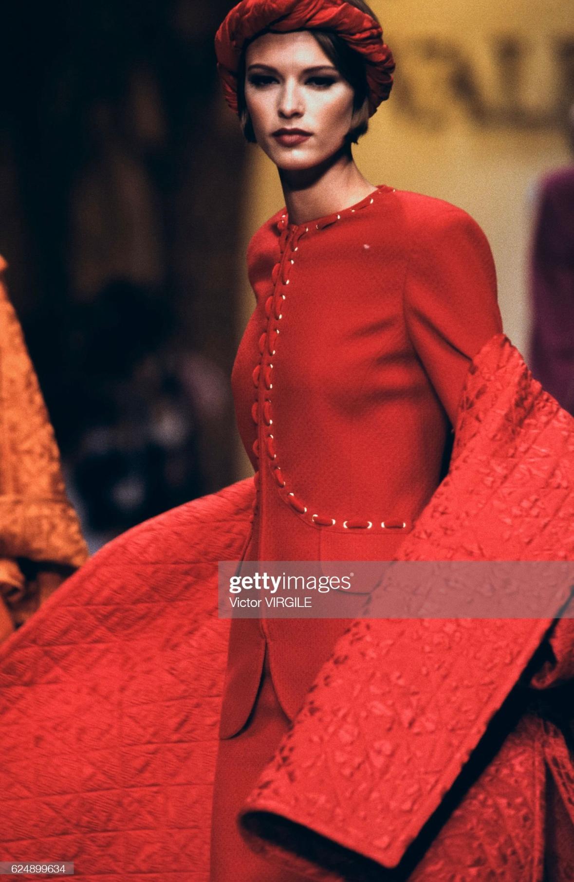 Presenting a bright red Valentino tweed jacket. From the Fall/Winter 1992 collection, this jacket debuted on the season's runway. The blazer features a crew neckline, zipper closure, laced velvet ribbon, and is made complete with gold-tone zodiac