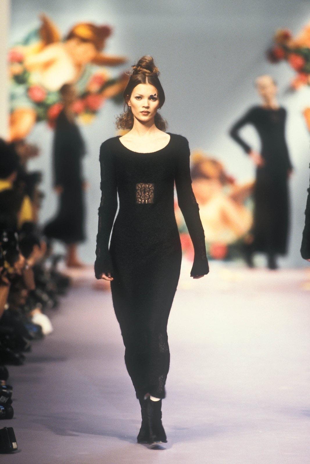 This Chloé black knit mohair dress from Fall/Winter 1993, designed by Karl Lagerfeld, debuted on the runway worn by Kate Moss. The form-fitting design features sheer lace panels on the bodice, sleeves, and hem, effortlessly combining soft texture