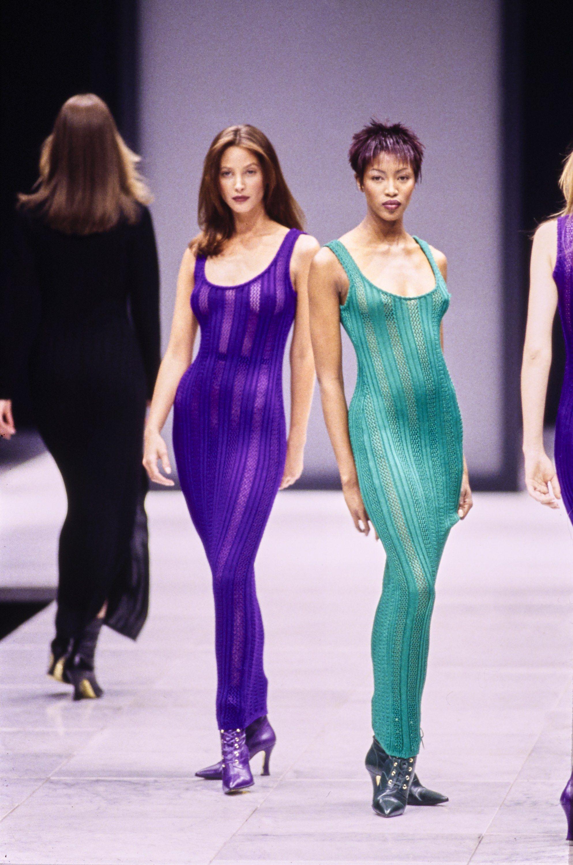 Presenting a sexy take on a knit dress, designed by Gianni Versace. Debuted as look number 32 on the Fall/Winter 1993 runway, modeled by Naomi Campbell, this set speaks for itself! Constructed of a knit/crochet fabric with a sheer matching slip