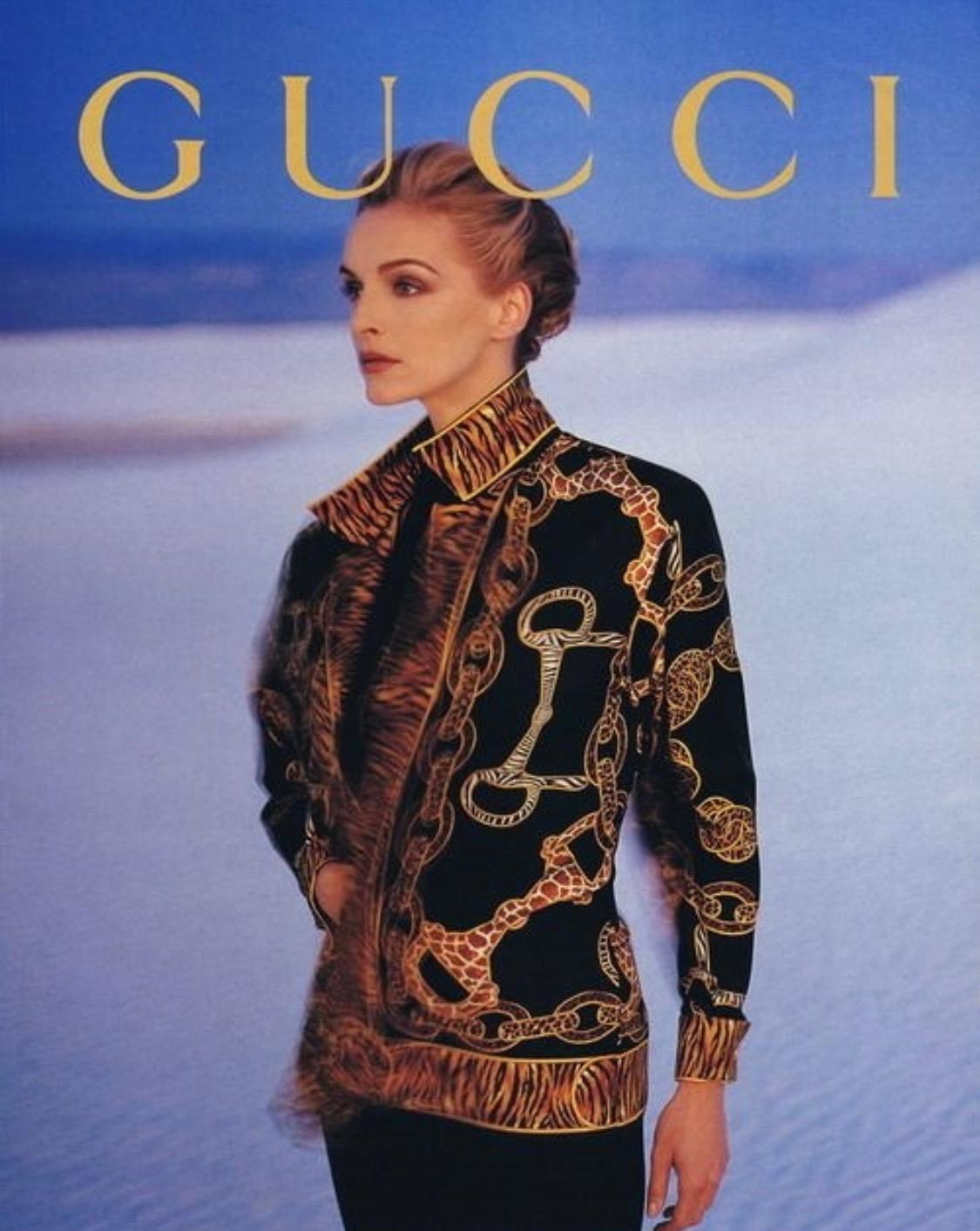 Presenting a rare animal horsebit print tunic top in black silk designed by Gucci for the Fall/Winter 1993 collection. As seen in the season's ad campaign on Simonetta Gianfelici, the button closure stops about halfway up the front for a plunging