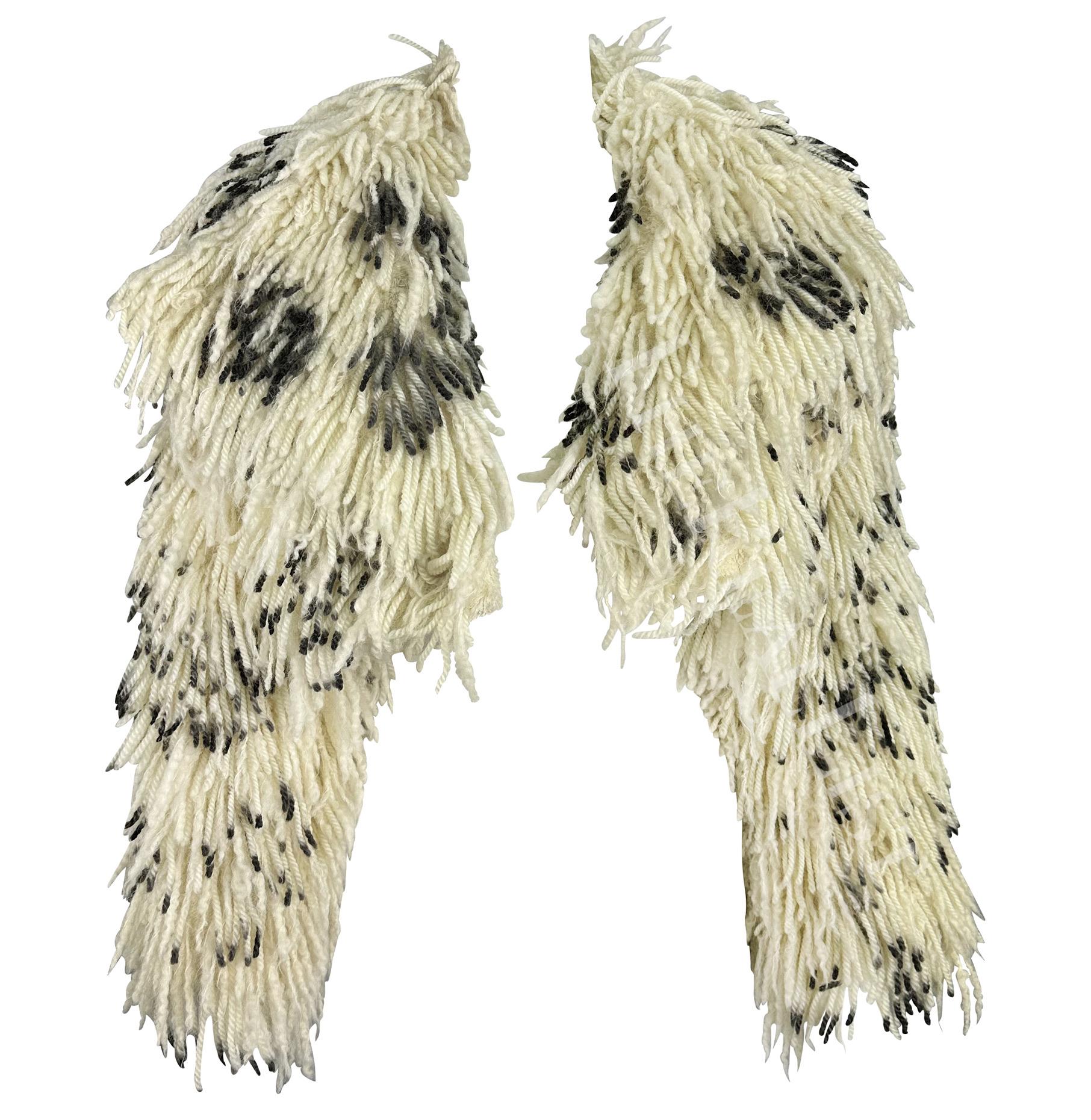 Presenting an incredible creme fringe Atelier Versace cropped coat. From the Fall/Winter 1994 collection, this voluminous coat is constructed of creme wool fringe with black spots scattered throughout. Similar shag fringe coats debuted on the