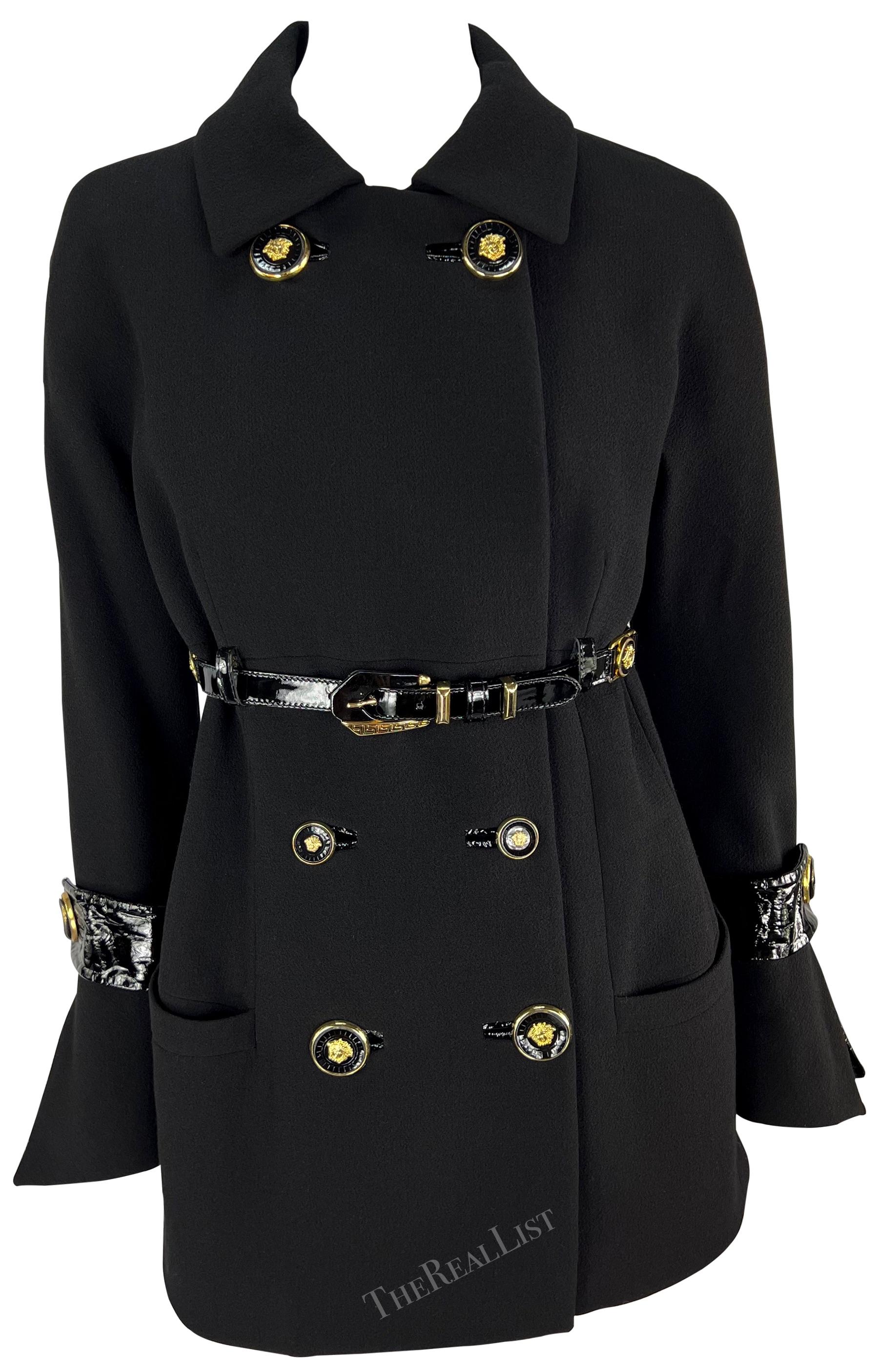 Presenting a fabulous black double-breasted Gianni Versace coat, designed by Gianni Versace. From the Fall/Winter 1994 collection, many similar styles debuted on the season's runway. This incredibly chic jacket features a double-breasted closure, a