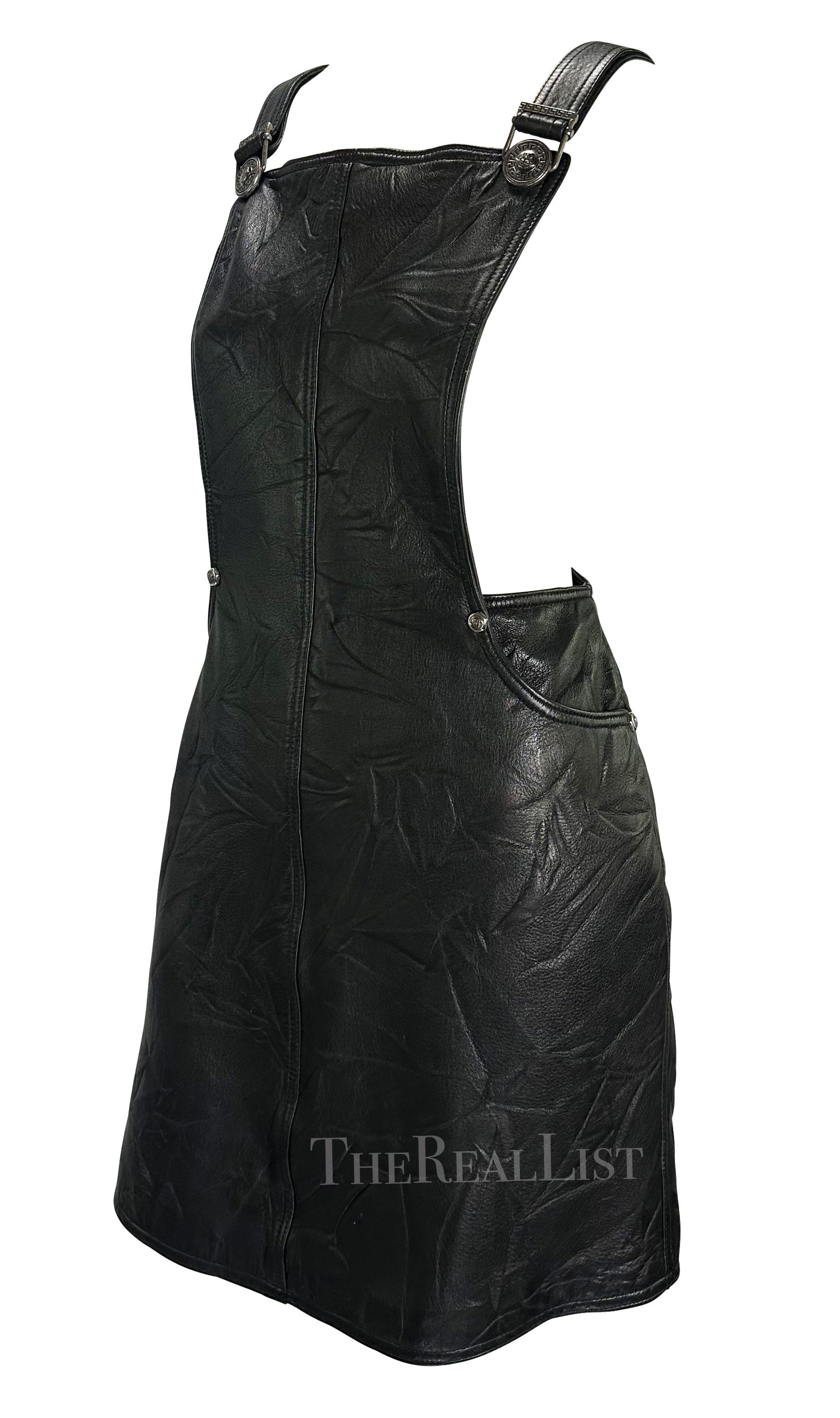 Presenting a fabulous black leather Gianni Versace overall style dress, designed by Gianni Versace. From the Fall/Winter 1994 collection this beautiful leather dress is intentionally wrinkled and creased - a motif that was heavily used in the