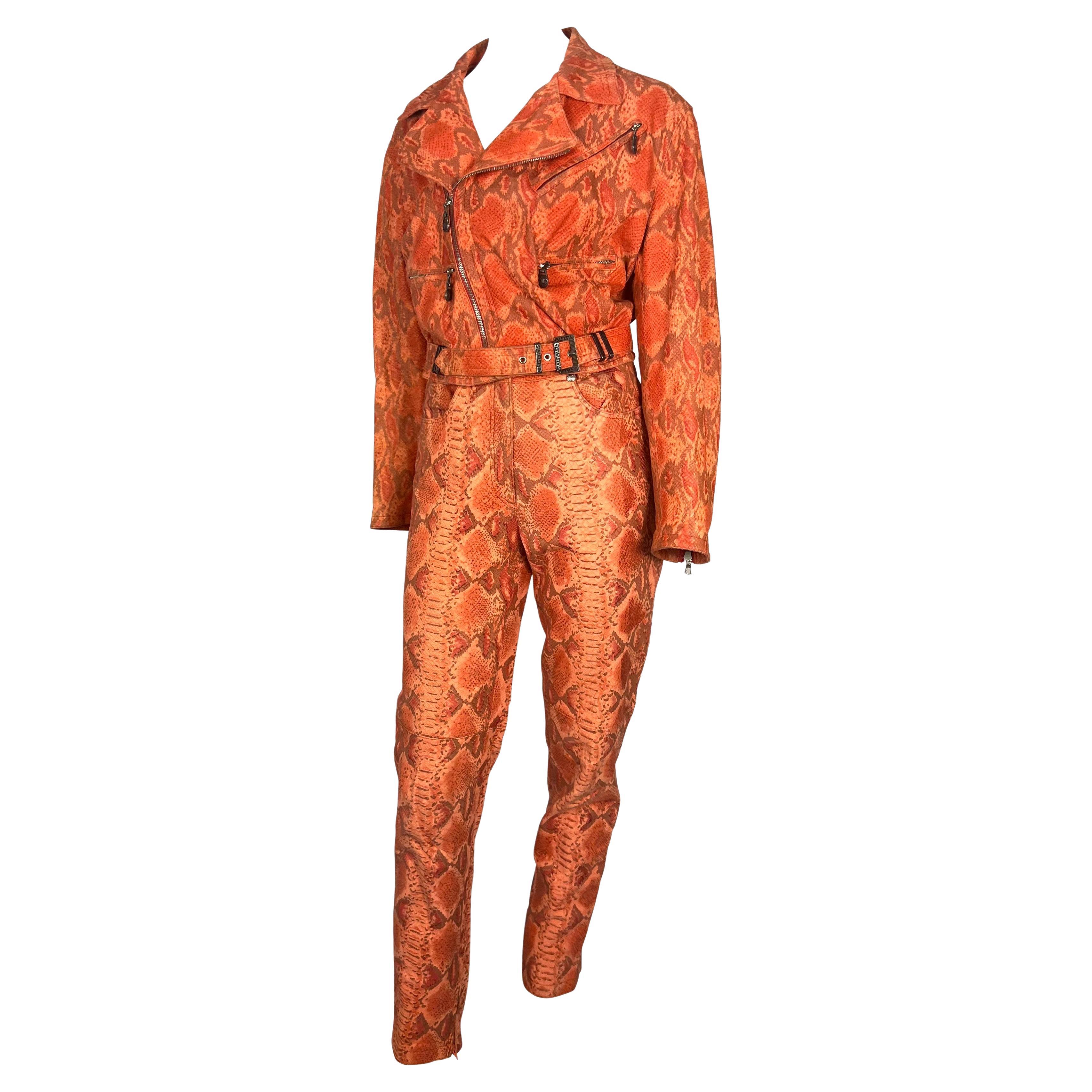 Presenting a fabulous snakeskin-embossed leather pant set, designed by Gianni Versace for his Fall/Winter 1994 collection. The jacket from this set debuted in several colors on the season's runway. This rare set is covered in orange and red