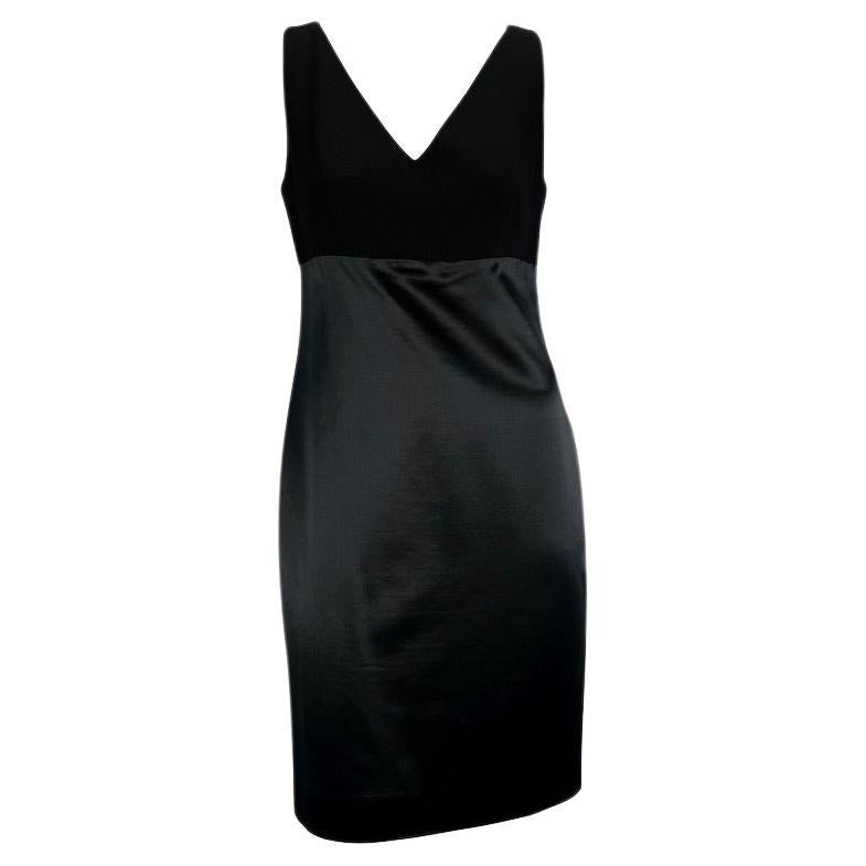Presenting a classic little black dress designed by Gianni Versace for his Fall/Winter 1995 collection. A satin skirt attached to a wool bodice beautifully hugs the curves of the body. Perfect for a night out or event, this subtle piece showcases