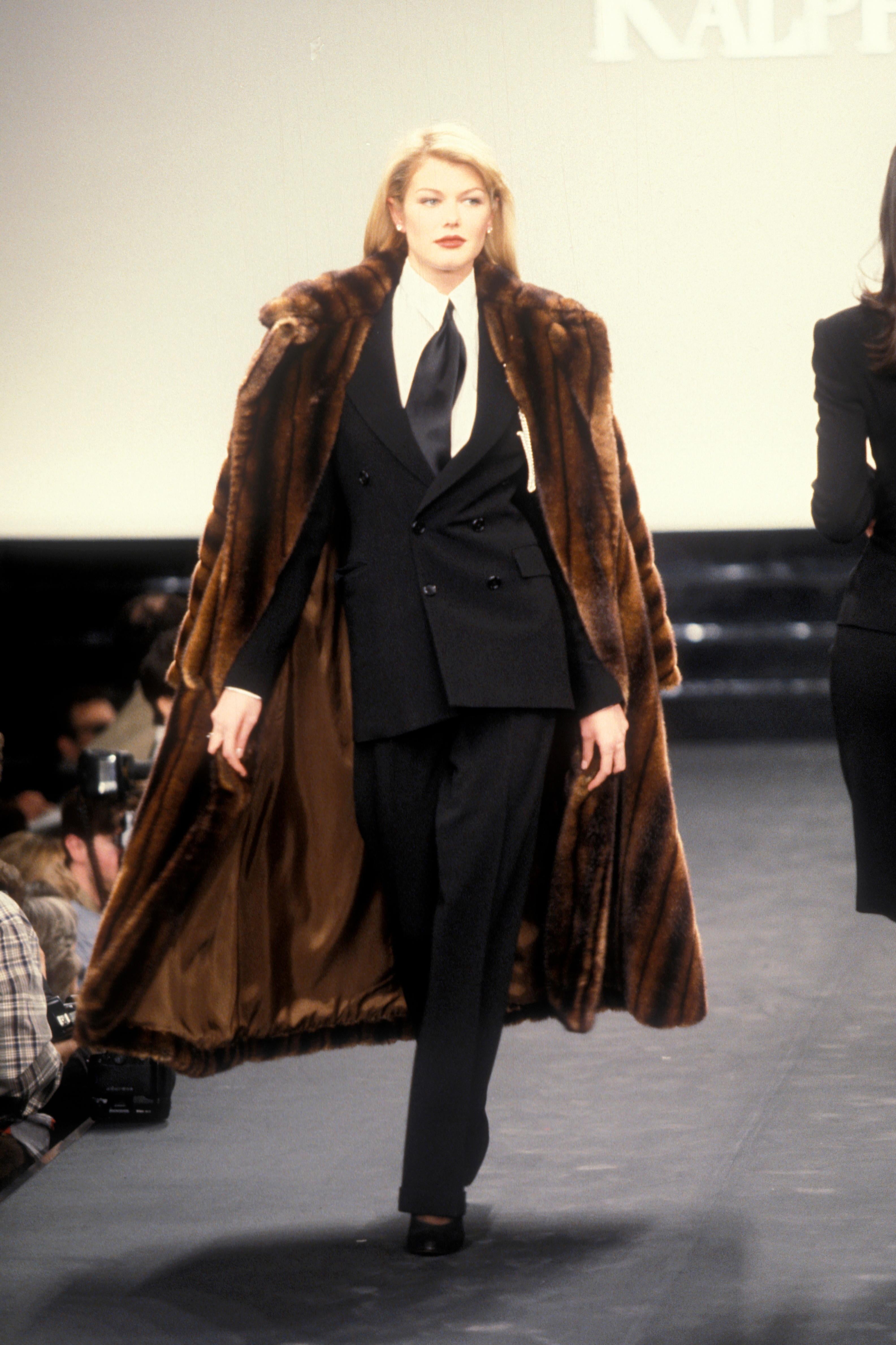 This faux sable mink fur coat from Ralph Lauren's Fall/Winter 1995 collection epitomizes quiet luxury with its oversized silhouette and dramatic shawl collar. Crafted to mimic the rich depth of sable mink, it features a belted waist for a structured