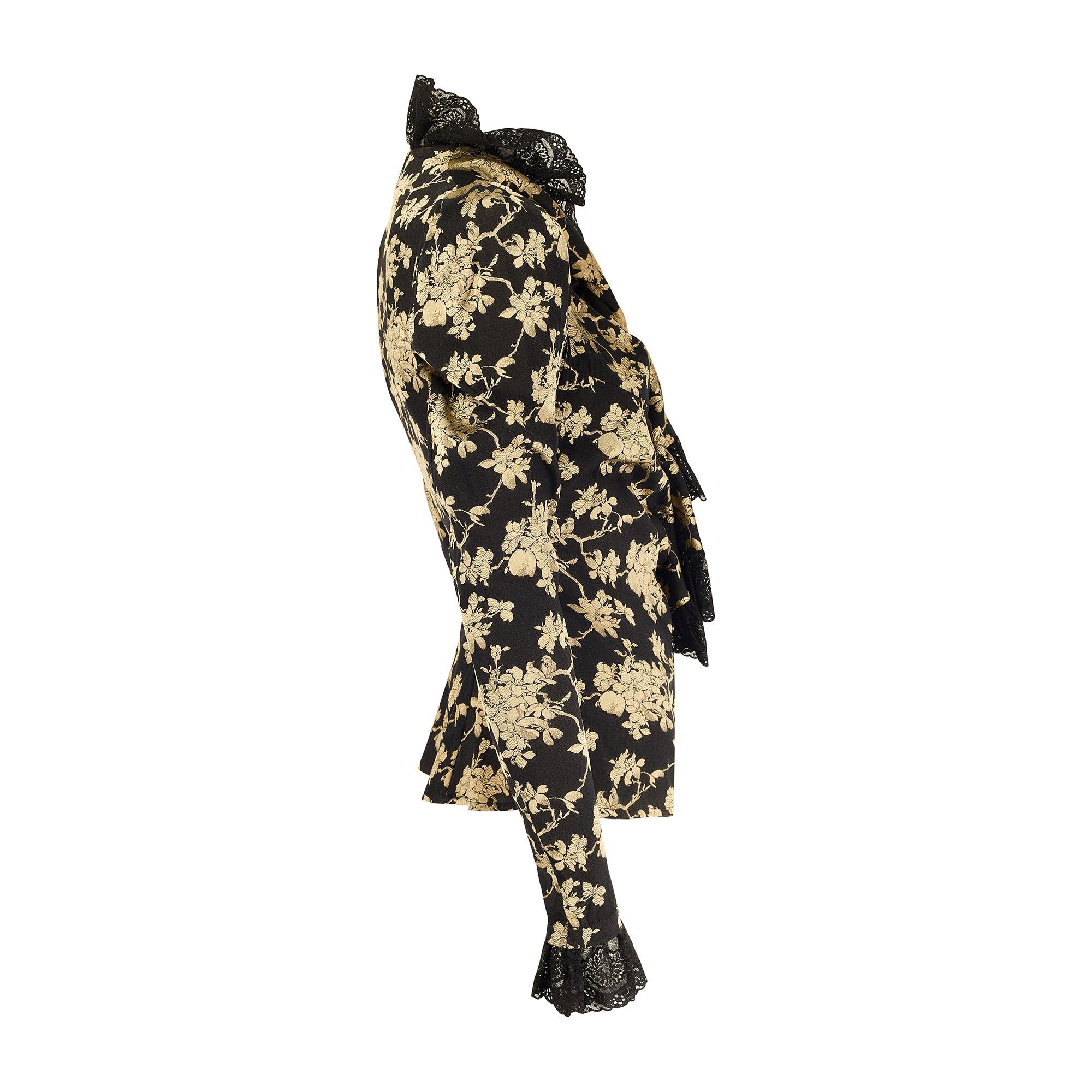 This well documented shirt is an early Gold Label item which Westwood starting using to denote her demi couture and runway collections from Fall 1993.  It is tailored from a decadent black and gold floral jacquard with leg o’mutton sleeves and slim