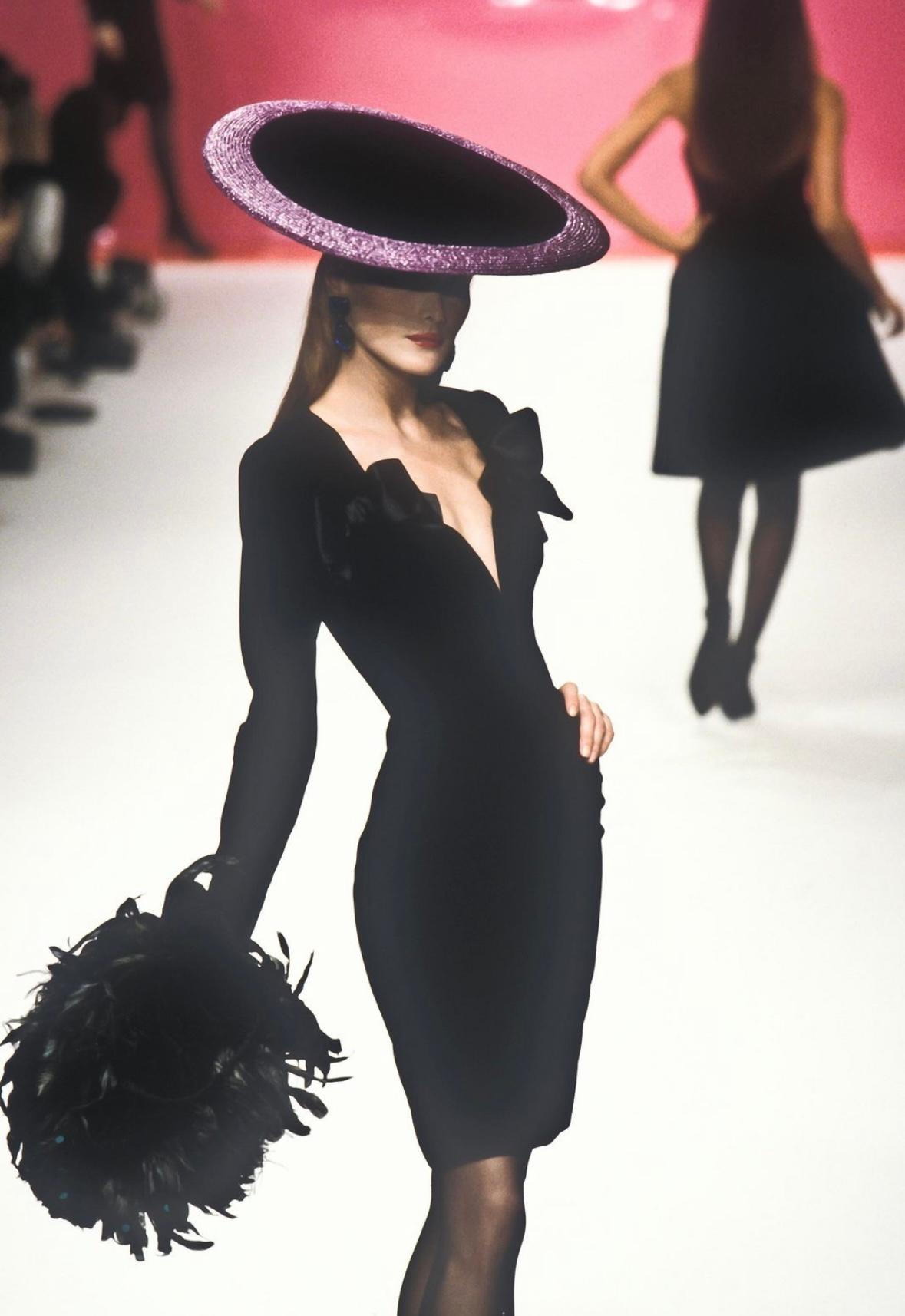 This exquisite dress is a timeless piece from Yves Saint Laurent's Fall/Winter 1995 collection. Crafted with luxurious deep blue velvet, the dress was originally showcased on the runway by Carla Bruni. As worn by Karen Mulder on the November 1995