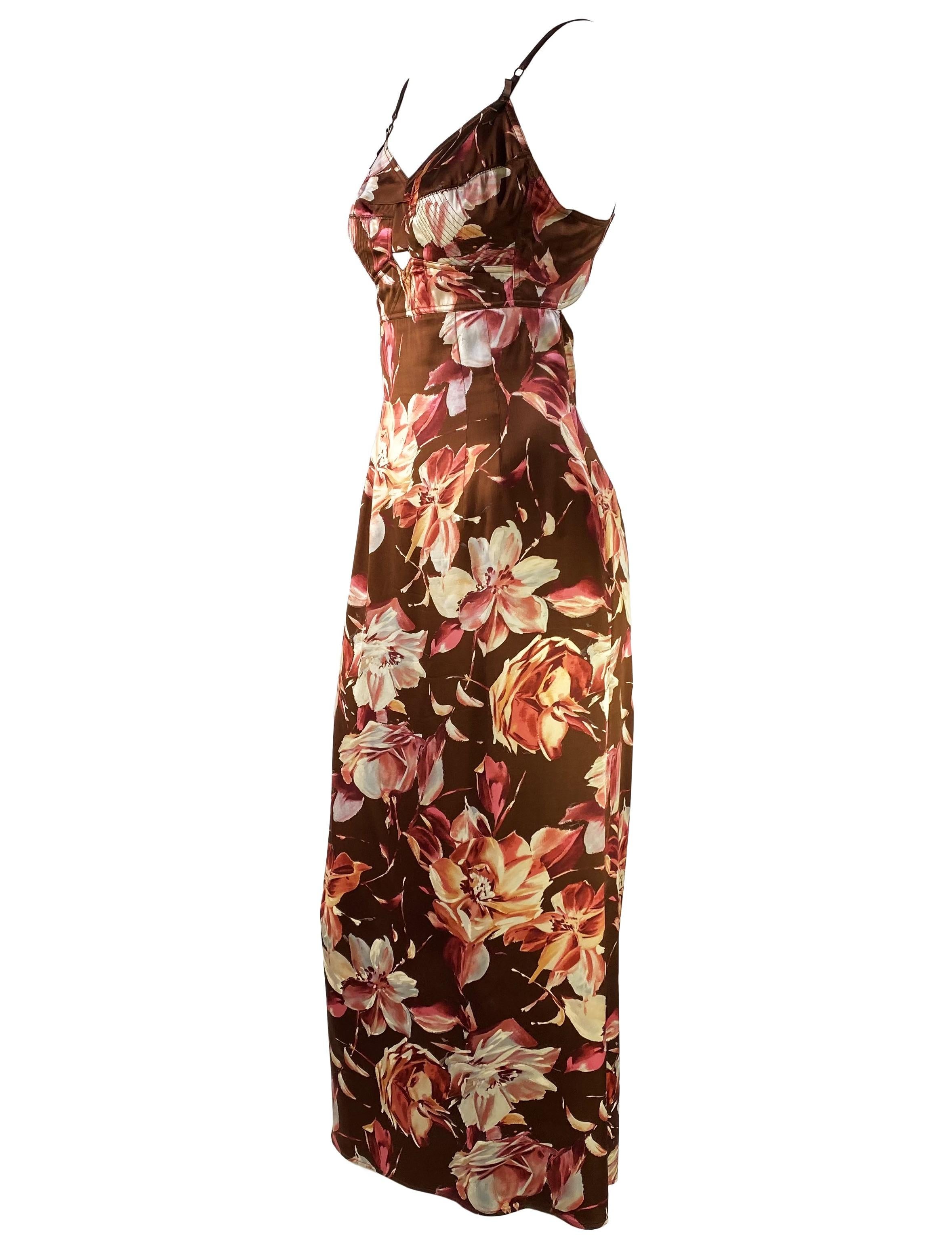 Presenting a stunning silk satin floral Dolce & Gabbana hourglass shape dress from their Spring/Summer 1997 collection. This dress debuted in the runway presentation in multiple similar floral fabric patterns. A small cutout at the bust and