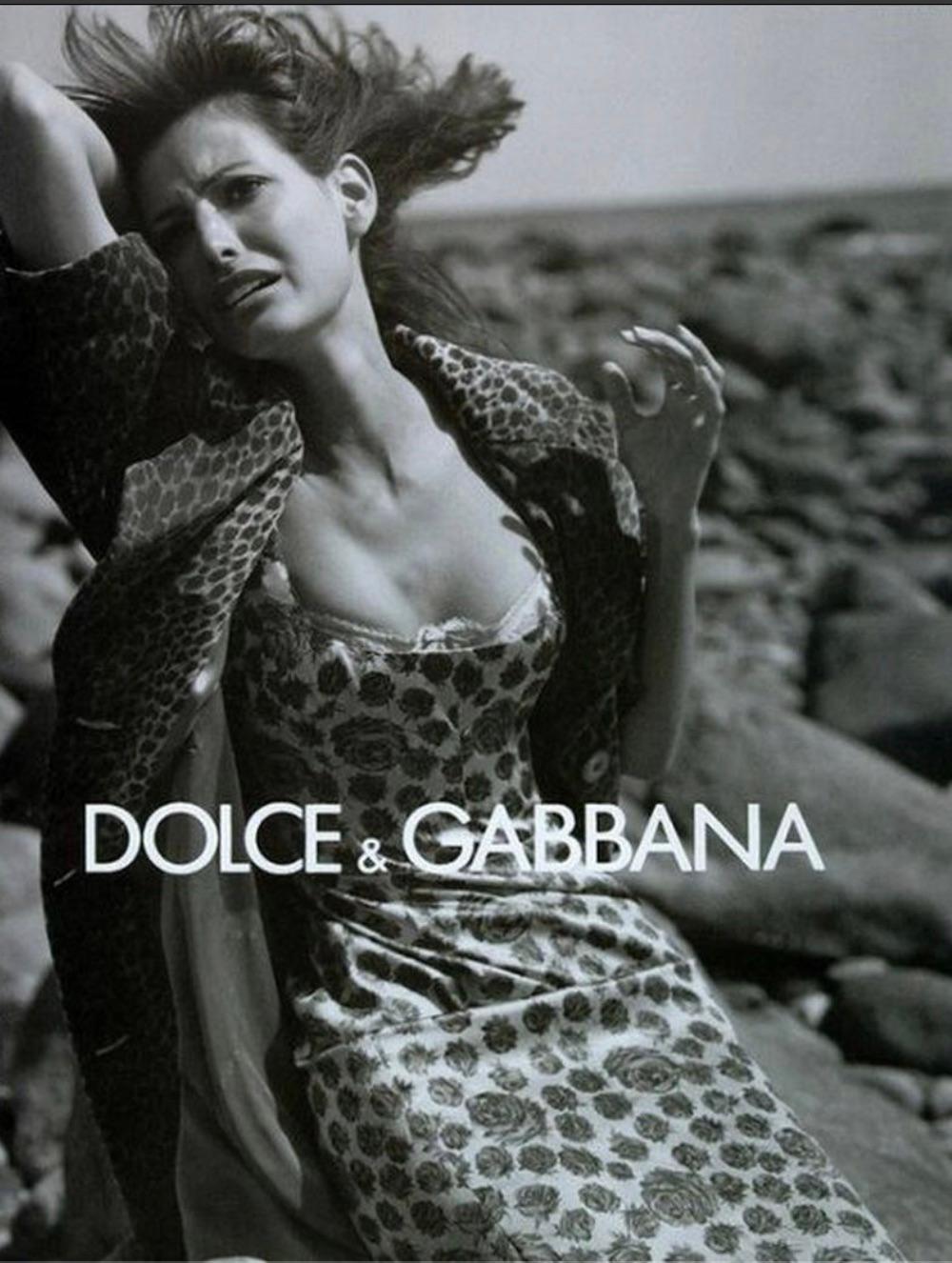 From the Fall/Winter 1996 collection, this sleeveless beige Dolce & Gabbana dress is adorned with a bold rose print and debuted on the season's runway. Highlighted in the season's ad campaign, captured by Steven Meisel and modeled by Elsa Benitez,