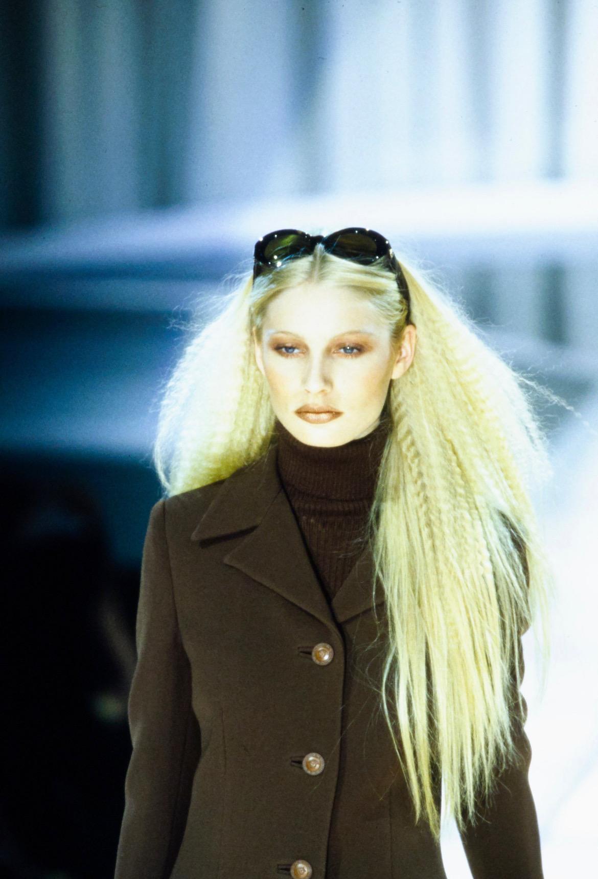 Presenting a pair of brown croc accented Gianni Versace sunglasses, designed by Gianni Versace. From the Fall/Winter 1996 collection, these sunglasses debuted as part of look 8 modeled by Kirsty Hume, and appeared several more times on the runway in