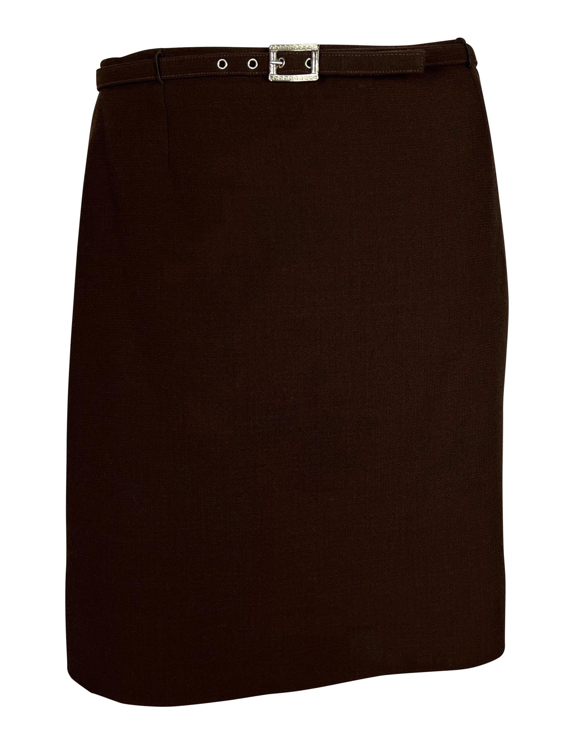 From the Fall/Winter 1996 collection, this chocolate brown Gianni Versace skirt suit includes a slightly cropped jacket and a matching pencil skirt. The jacket features a fold-over collar, silver-tone Versace Medusa buttons on the front and cuffs,