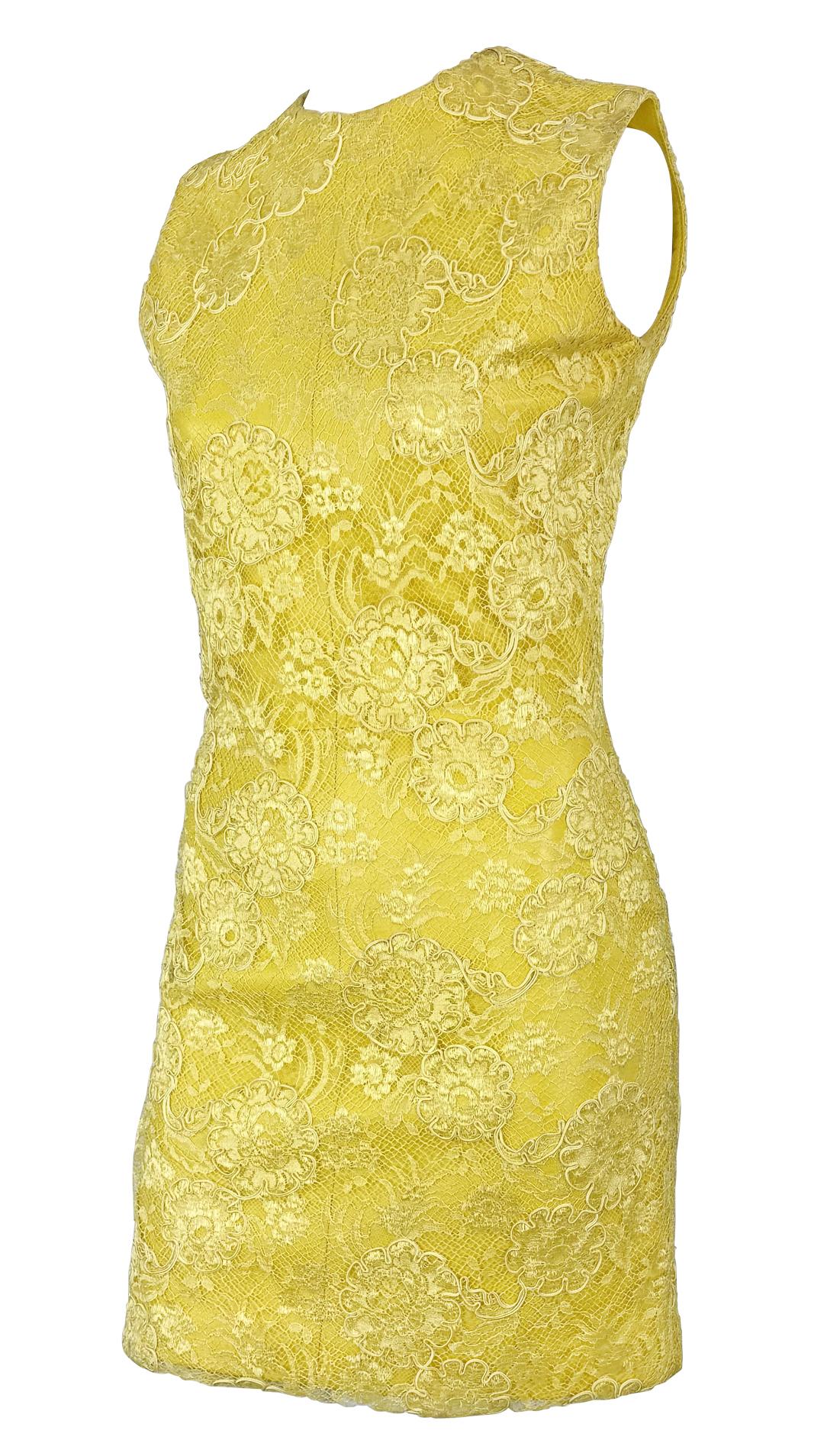 From Gianni Versace’s Fall/Winter 1996 collection, this sleeveless mini dress features a bold yellow leather base with an intricate floral lace overlay. 

Approximate measurements:
Size - removed
Bust: 34