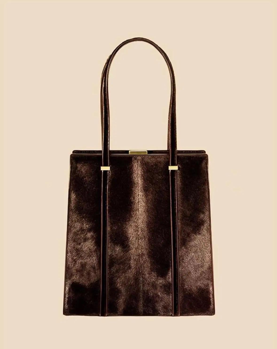 From Gucci’s Fall/Winter 1996 collection by Tom Ford, this medium shoulder bag is crafted from genuine black python skin with a structured silhouette. It features dual shoulder straps and gold-tone hardware accents, like a nearly identical bag shown