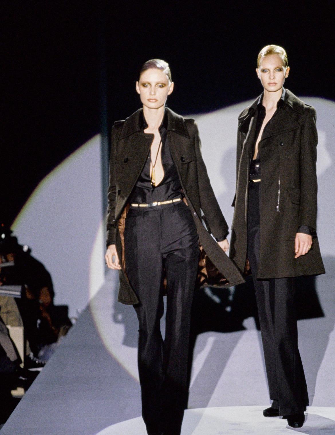 Wir präsentieren einen unglaublichen Gucci-Mantel aus schwarzer Wolle, entworfen von Tom Ford. Aus der Herbst/Winter-Kollektion 1996 wurden auf dem Laufsteg ähnlich geschnittene Mäntel in Braun und Marineblau gezeigt. Dieser fabelhafte Mantel hat