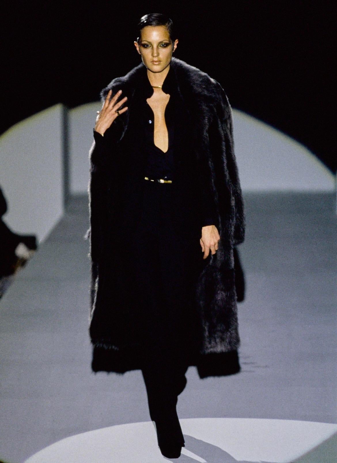 TheRealList presents: a fabulous dark brown faux fur Gucci double-breasted trench coat, designed by Tom Ford. From the Fall/Winter 1996 collection, this coat debuted on the season's runway modeled by Chandra North with a longer version following it