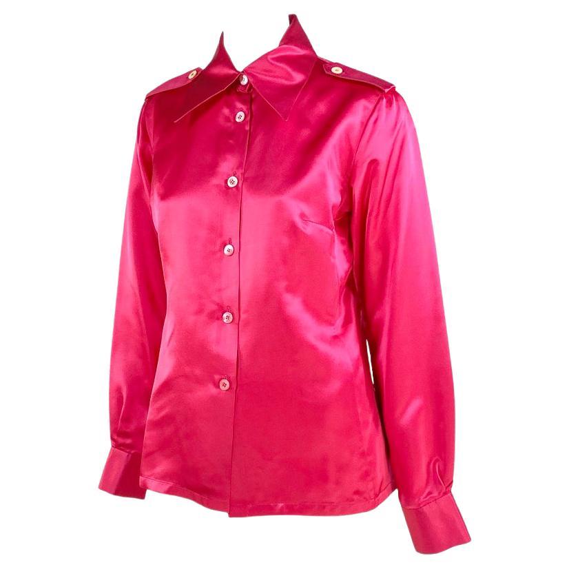 Presenting a collared button up incredible pink silk Gucci top, designed by Tom Ford. This top has long sleeves, a prominent collar, shoulder pads, and epaulets. Words and pictures cannot depict how amazing the fabric on this shirt is in person.