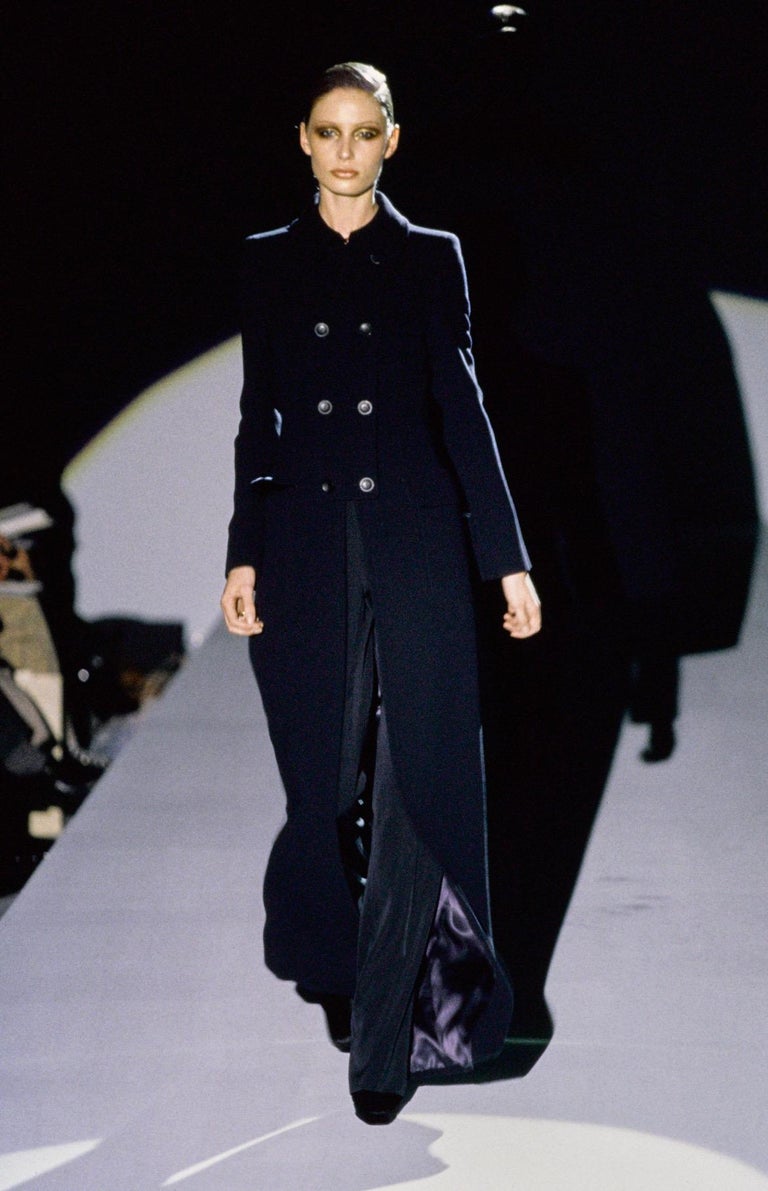 TheRealList presents: a fabulous navy wool oversized Gucci trench coat, designed by Tom Ford. From the Fall/Winter 1996 collection, this coat debuted on the season's runway and features a large abstract Gucci 'G' at the back that was heavily used in