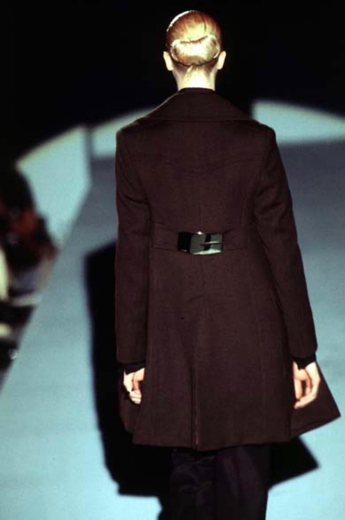 Presenting Tom Ford's reinvented modern take on Gucci's 'G' prominently placed on a classic brown wool coat. This Gucci by Tom Ford creation is from the F/W 1996 collection, the same oversized buckle was heavily featured on the runway and remains an