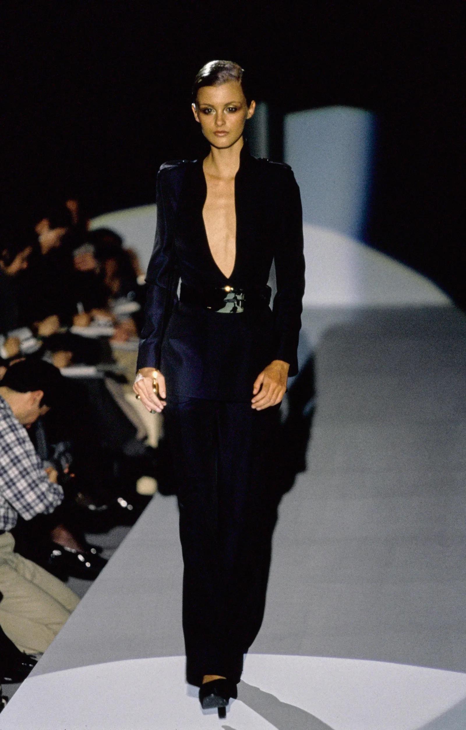 Presenting a stunning iridescent navy Gucci pantsuit, designed by Tom Ford. From the Fall/Winter 1996 collection, this suit debuted on the season's runway as look 5, modeled by Trish Goff and appeared on the July 1996 cover of Elle Magazine on Meg