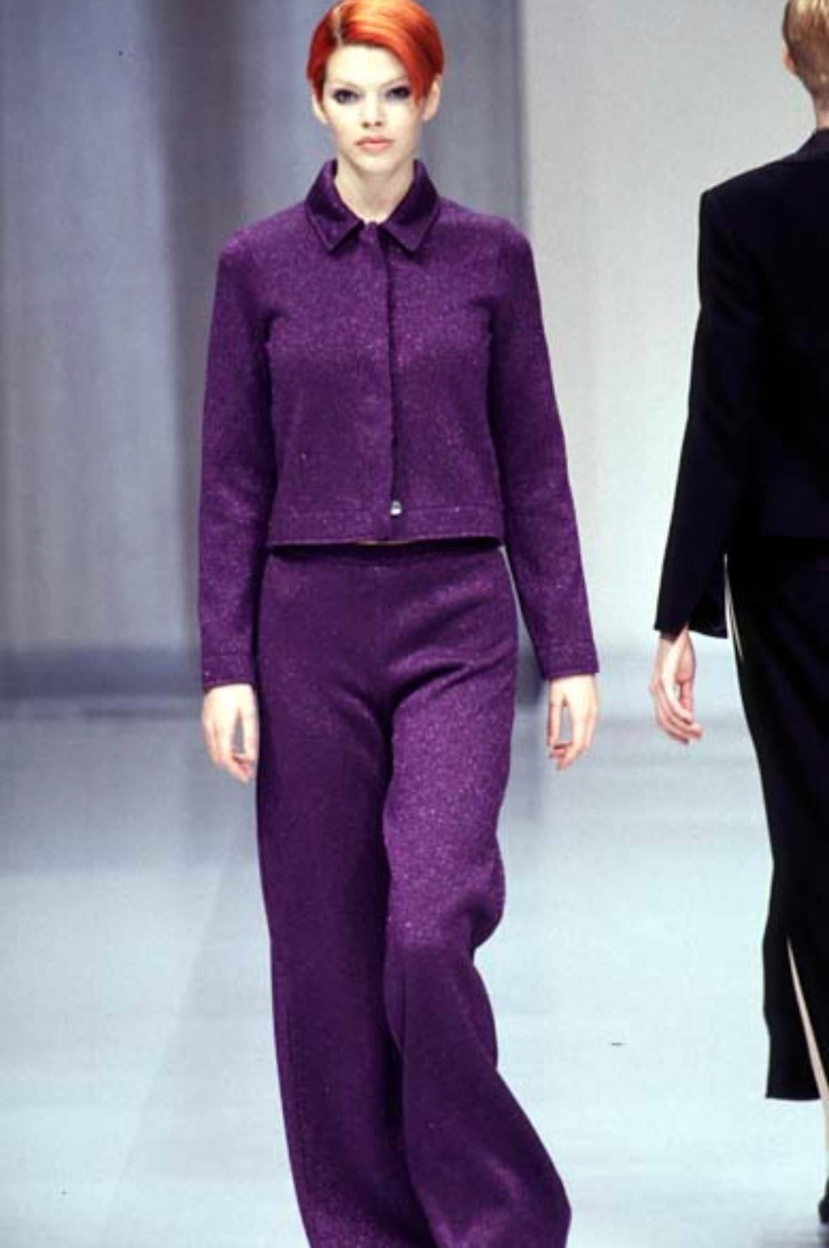 Presenting a fabulous dark purple Salvatore Ferragamo knit jacket. From the Fall/Winter 1996 collection, this jacket features a fold-over collar and concealed button closure. This metallic woven jacket debuted on the runway and perfectly catches
