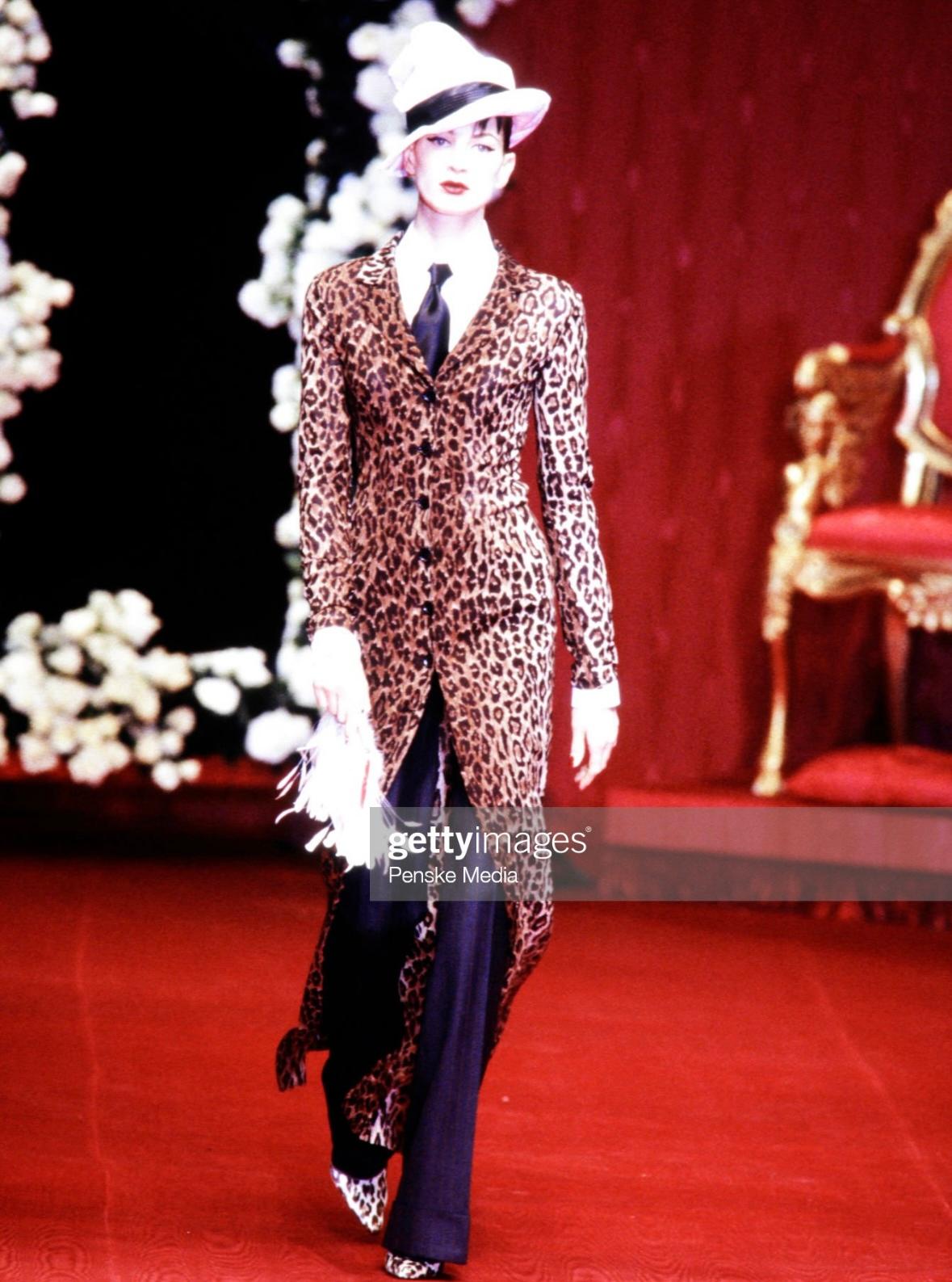 Presenting a stunning Dolce and Gabbana cheetah maxi coat dress. From the Fall/Winter 1997 collection, a version of this coat dress debuted on the season's runway on Kristen McMenamy. The duster is constructed of a semi-sheer cheetah print fabric