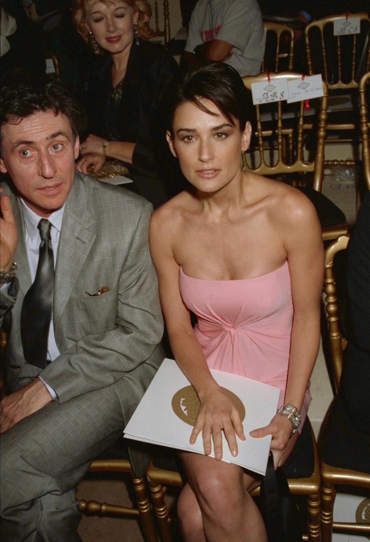 This strapless pink Gianni Versce mini dress from the Fall/Winter 1997 collection debuted on the season's runway and features an internal corse. This iconic design was worn by Demi Moore at a Gianni Versace runway show, Elizabeth Hurley in a