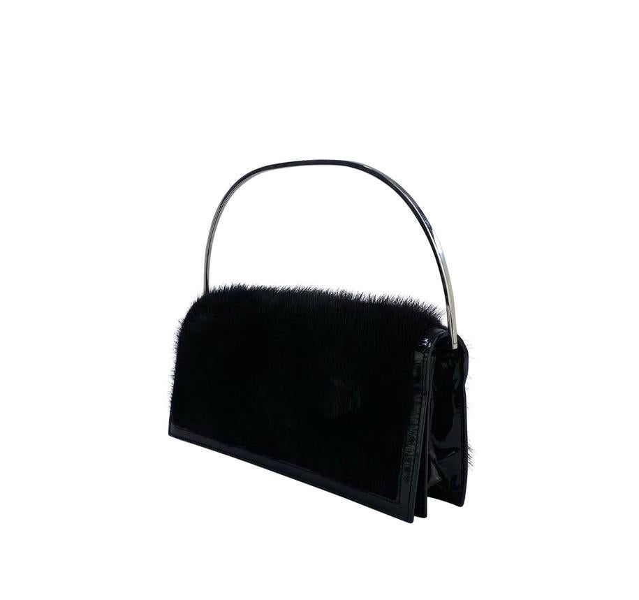 TheRealList presents: a gorgeous black mink and patent leather Gucci clutch, designed by Tom Ford.  This bag, from the Fall/Winter 1997 collection is seldom found and can be used as a clutch or handle bag. The body of the bag features black mink fur