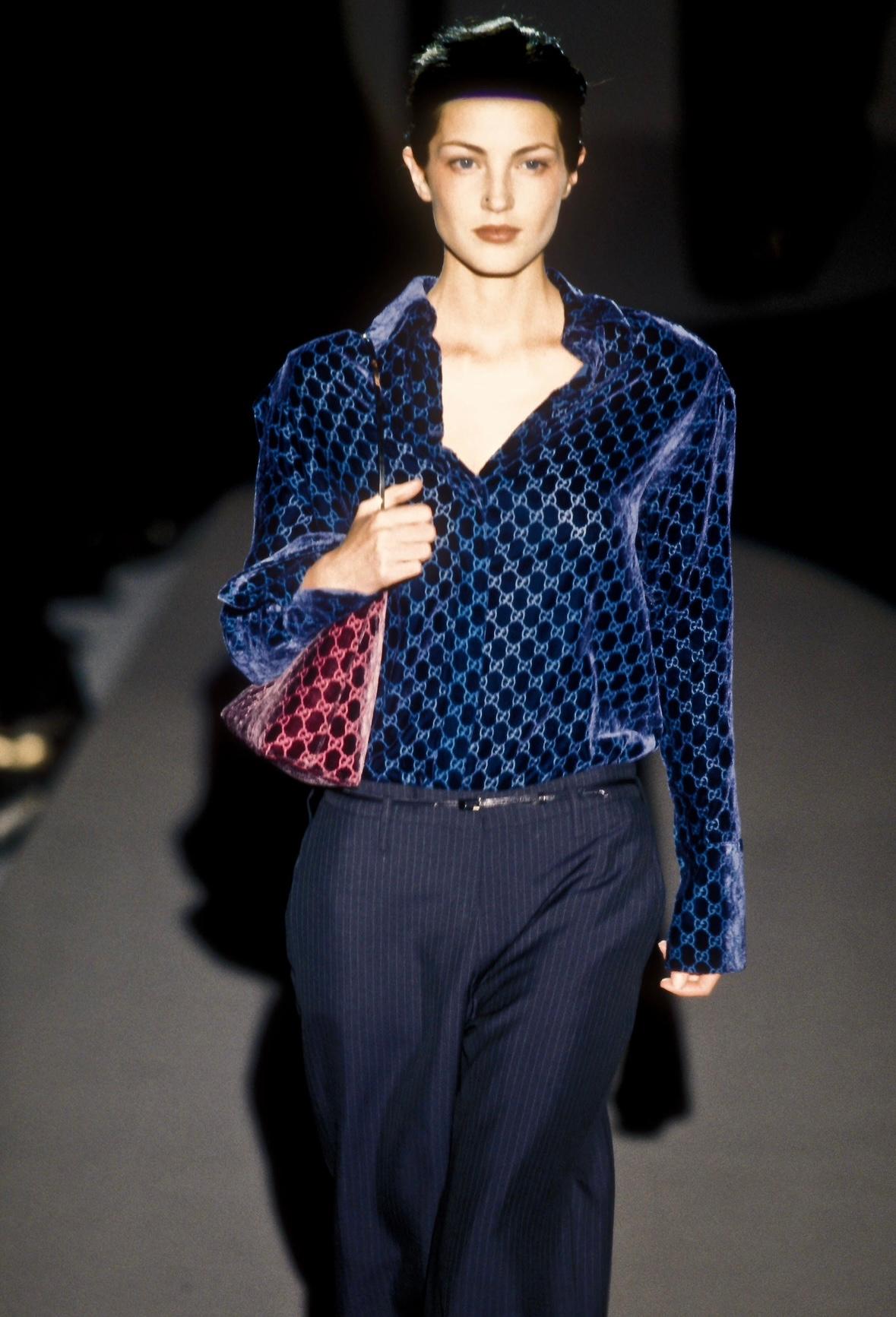 Presenting an iconic burgundy Gucci 'GG' monogram bucket bag designed by Tom Ford. From the Fall/Winter 1997 collection, this fabulous bag is constructed of a deep purple/burgundy silk velvet body and is complete with a silver plated handle. The bag