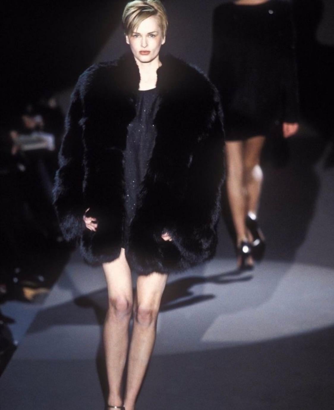 Presenting one of Tom Ford's most lusted-after designs during his tenure at the house of Gucci. This oversized black fox fur chubby coat debuted on Fall/Winter 1997 runway presentation on Kylie Bax. The coat is lined in matching black 'GG' monogram