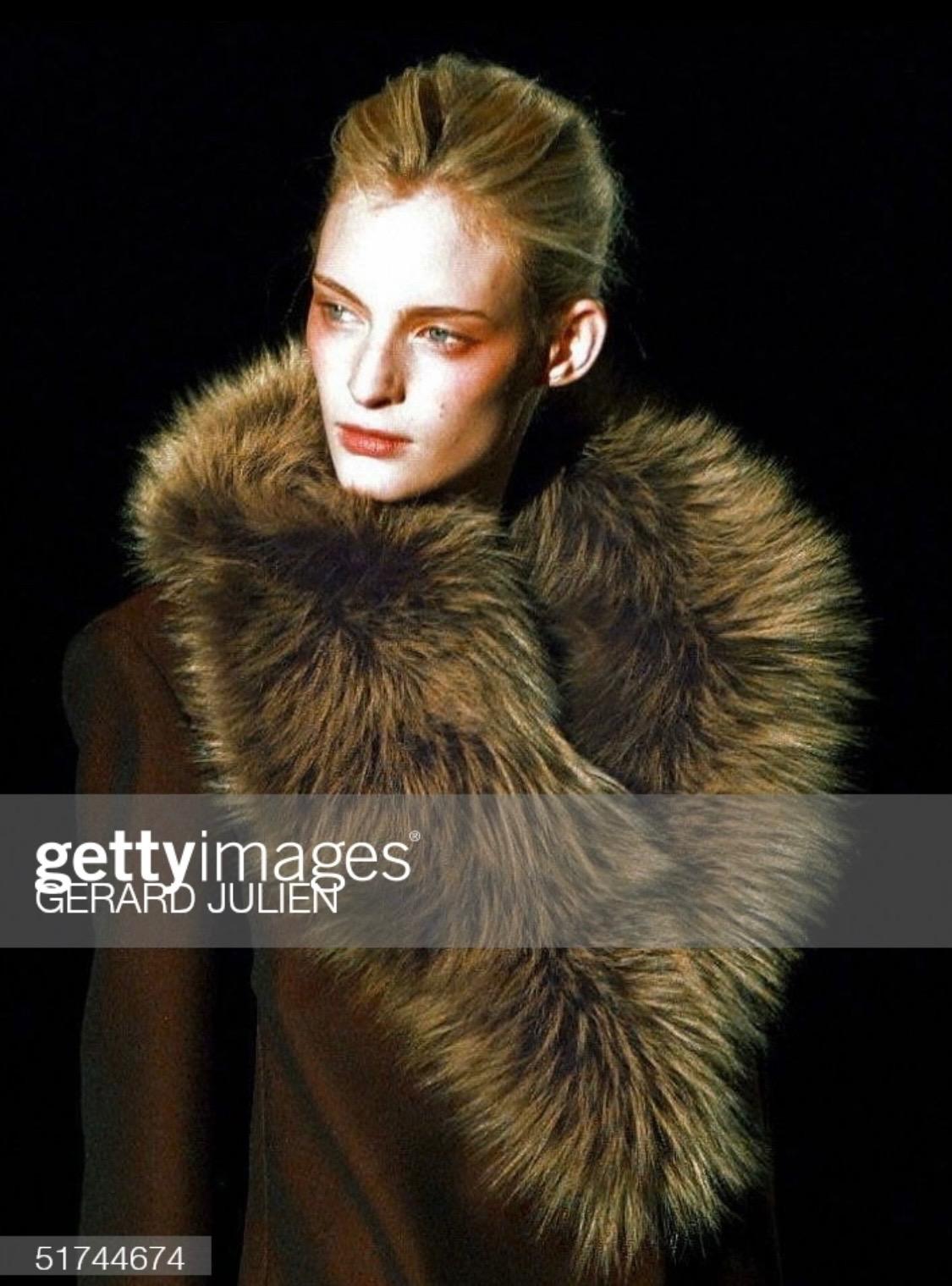 Presenting a fabulous mohair coat trimmed in contrasting green fur at the lapel. This piece was designed by Tom Ford for Gucci's Fall/Winter 1997 runway collection, which is remembered for its sleek minimalism with bold accent colors. The buttons