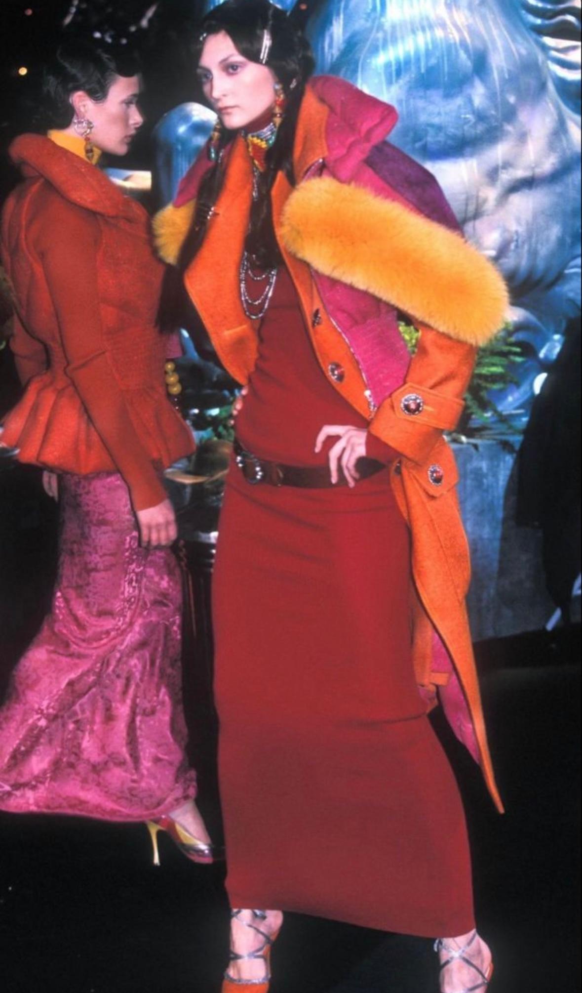 This Christian Dior by John Galliano gilet from the Fall/Winter 1998 collection is crafted from vibrant pink tweed with subtle multicolor flecks. The vest design features a high funnel neck with silver-tone button closures, a full front zip, and a