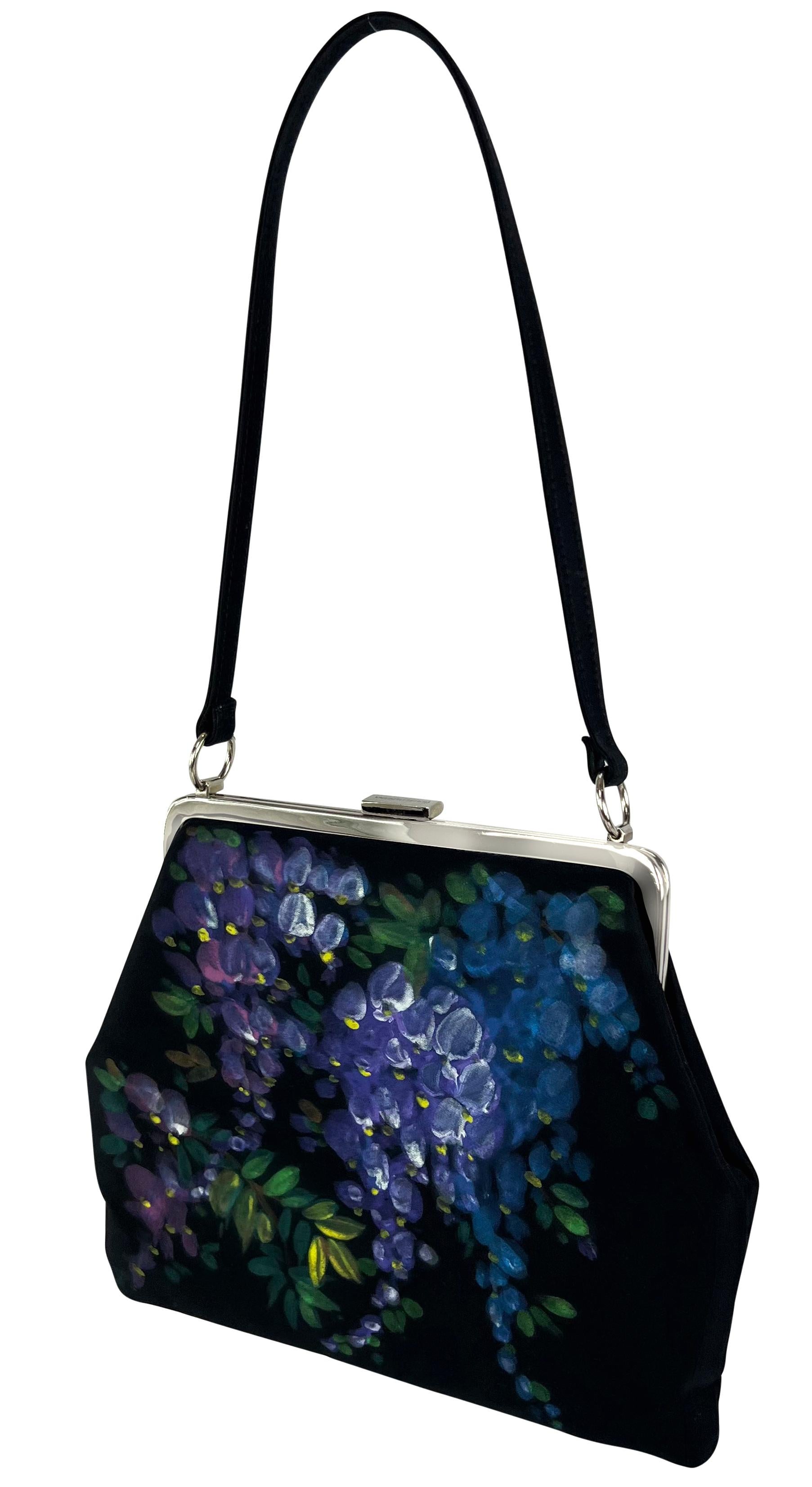 Presenting a fabulous black hand-painted grape Dolce and Gabbana bag. This bag from the Fall/Winter 1998 collection features a silver-plated clamshell closure and a black silk body, complete with a hand-painted wisteria pattern. The runway