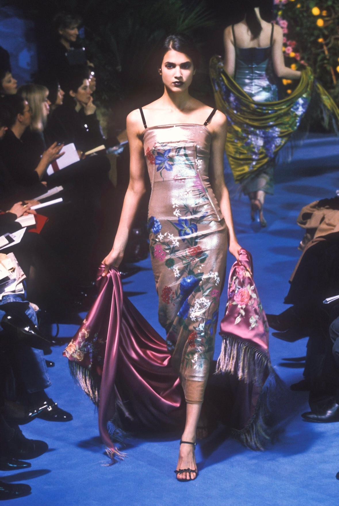 Presenting a truly stunning hand-painted Dolce & Gabbana metallic mesh gown. From the Spring/Summer 1998 collection, this nearly floor-length gown debuted on the season's runway and with a similar version of the dress highlighted on the cover of the