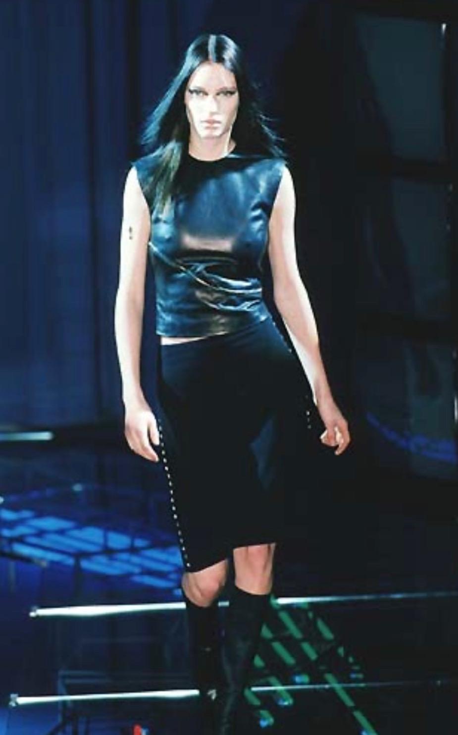 TheRealList presents: an asymmetric zipper accented leather crop top designed by Donatella for the Gianni Versace Fall/Winter 1998 collection. Debuting on look 3 on the season's menswear runway, this piece is constructed of soft leather perfectly