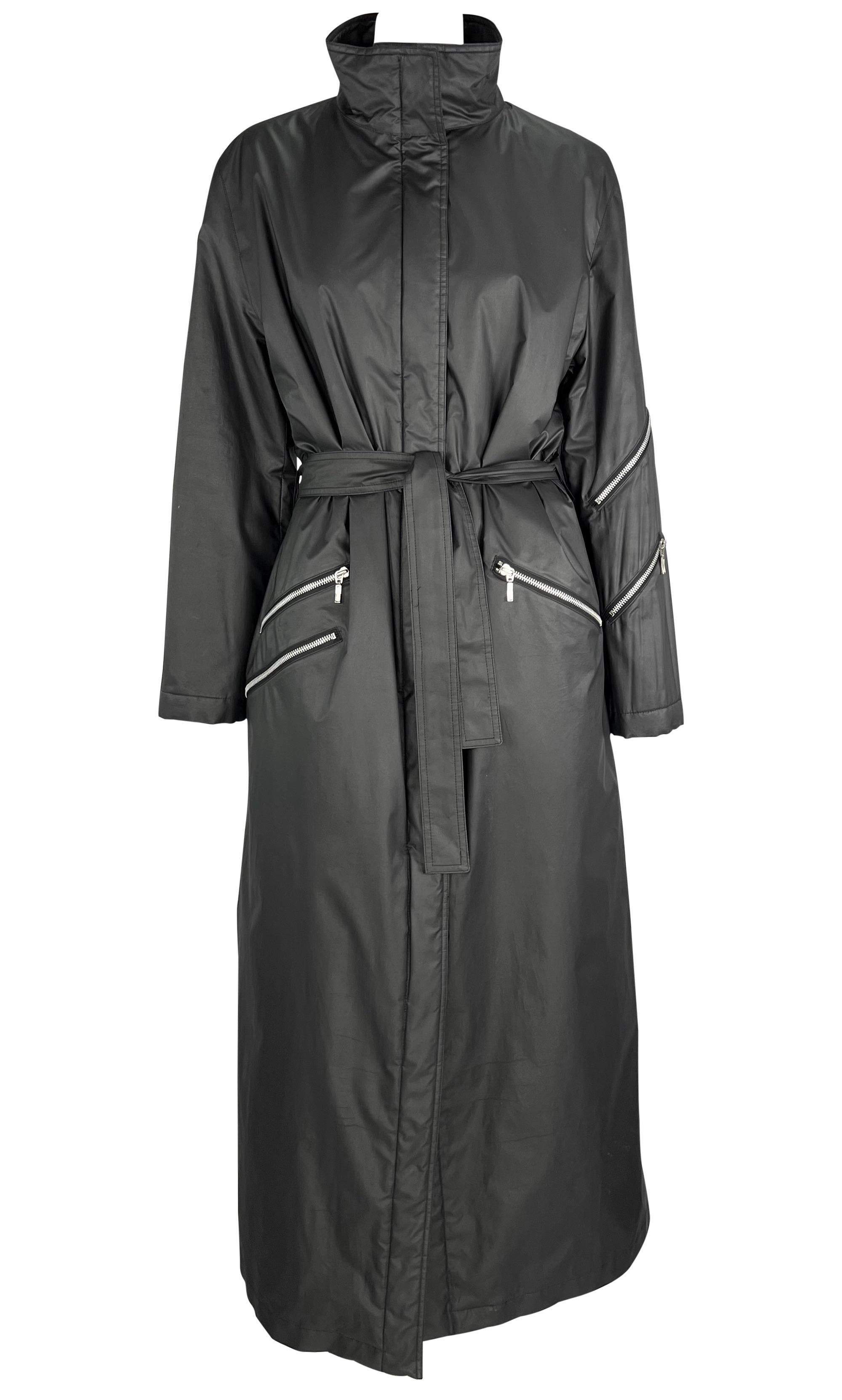 Donatella Versace ha disegnato questo cappotto nero incredibilmente chic in nylon imbottito di Gianni Versace per la collezione Autunno/Inverno 1998. Questo favoloso cappotto lungo fino alla caviglia è caratterizzato da un collo alto, tasche con