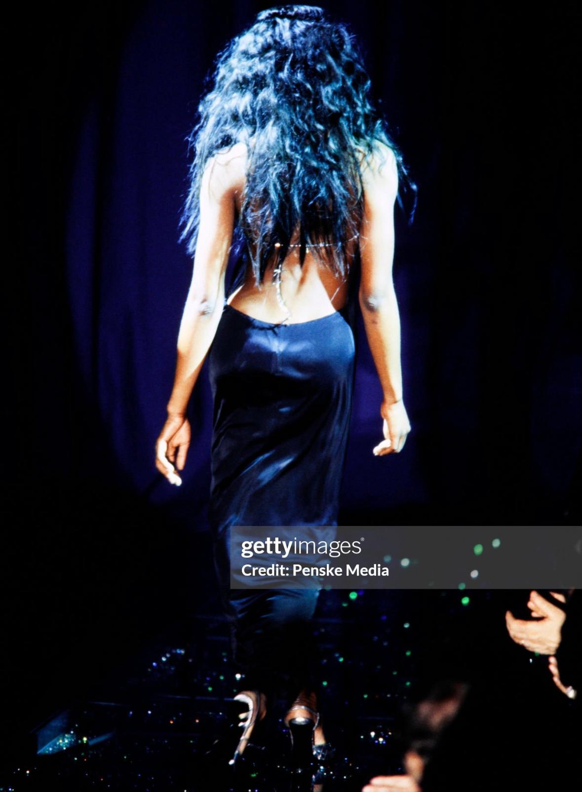 Donatella Versace designed this black backless Gianni Versace gown for the brand's Fall/Winter 1998 collection. Worn by Naomi Campbell on the runway, this gown was also highlighted in the season's ad campaign, modeled by Jade Parfitt and captured by