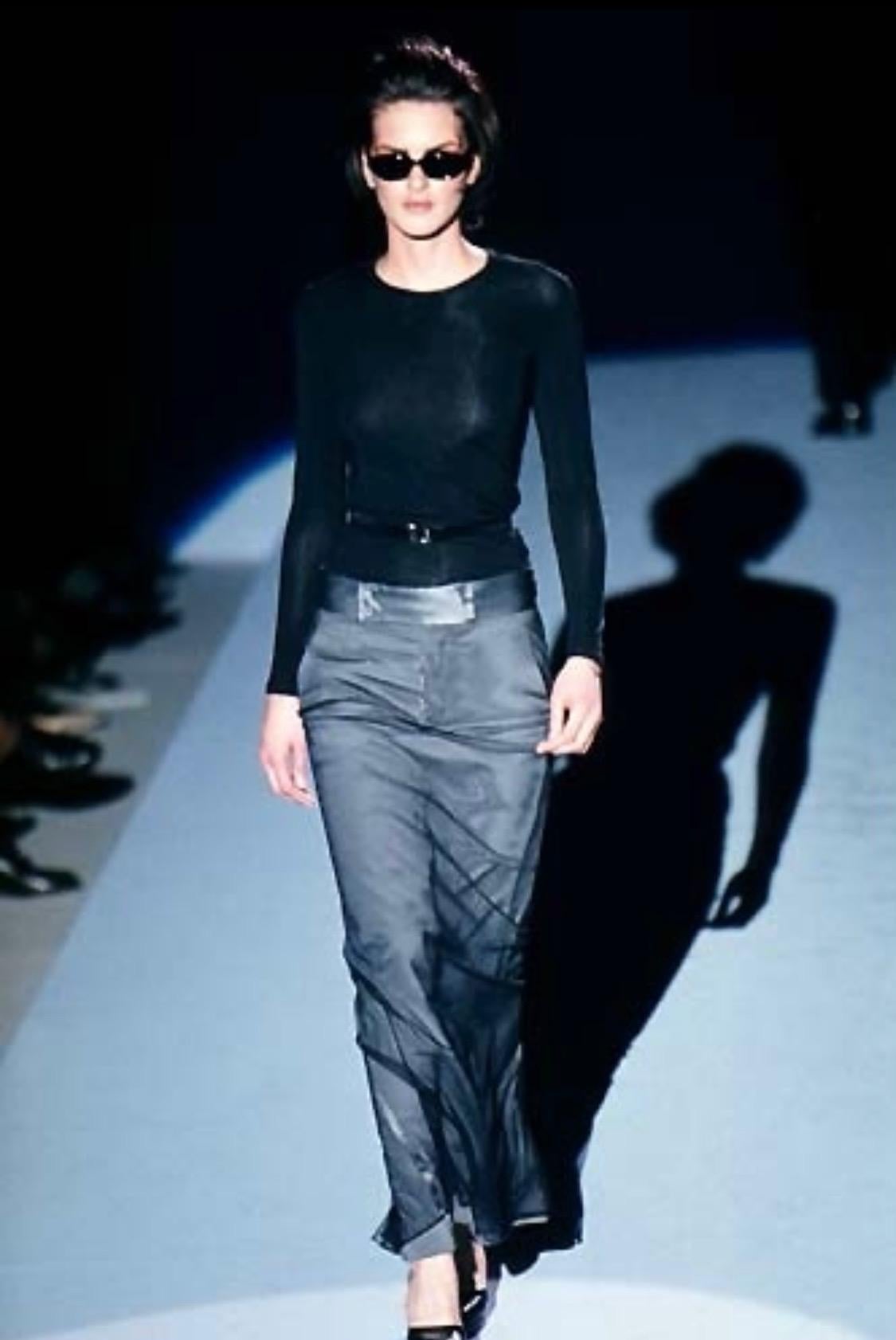 Presenting a full-length Gucci skirt, designed by Tom Ford. From the Fall/Winter 1998 collection, this skirt features a button closure, belt loops, and buckles at the waist which are all covered by a layer of tulle. Debuting on the runway, this