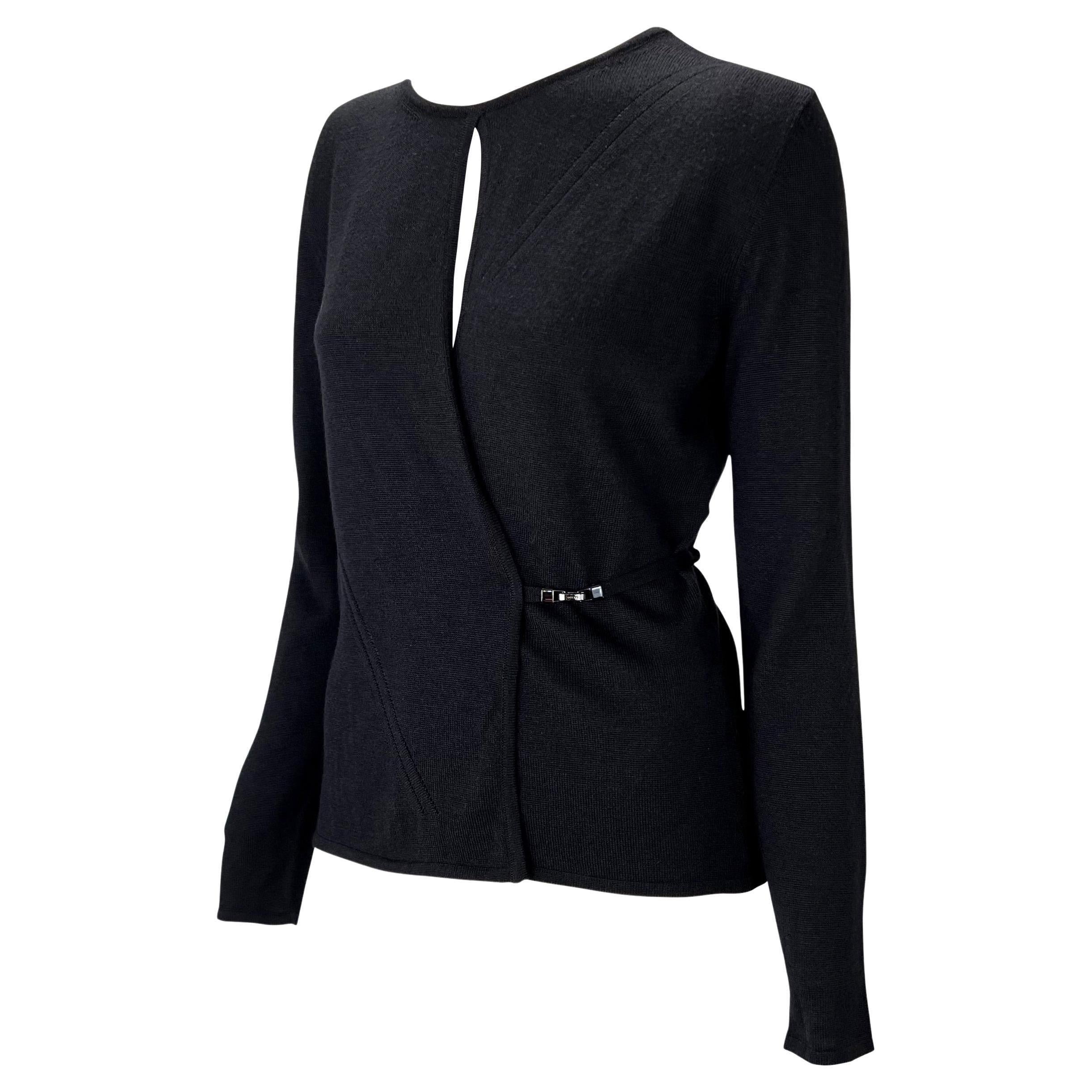 Présentation d'un pull noir Gucci enveloppant, conçu par Tom Ford. Issu de la collection automne-hiver 1998, ce pull unique est doté d'un fil de tissu qui s'enroule autour de la taille et se raccorde sur le devant par une fermeture en métal. Ce pull