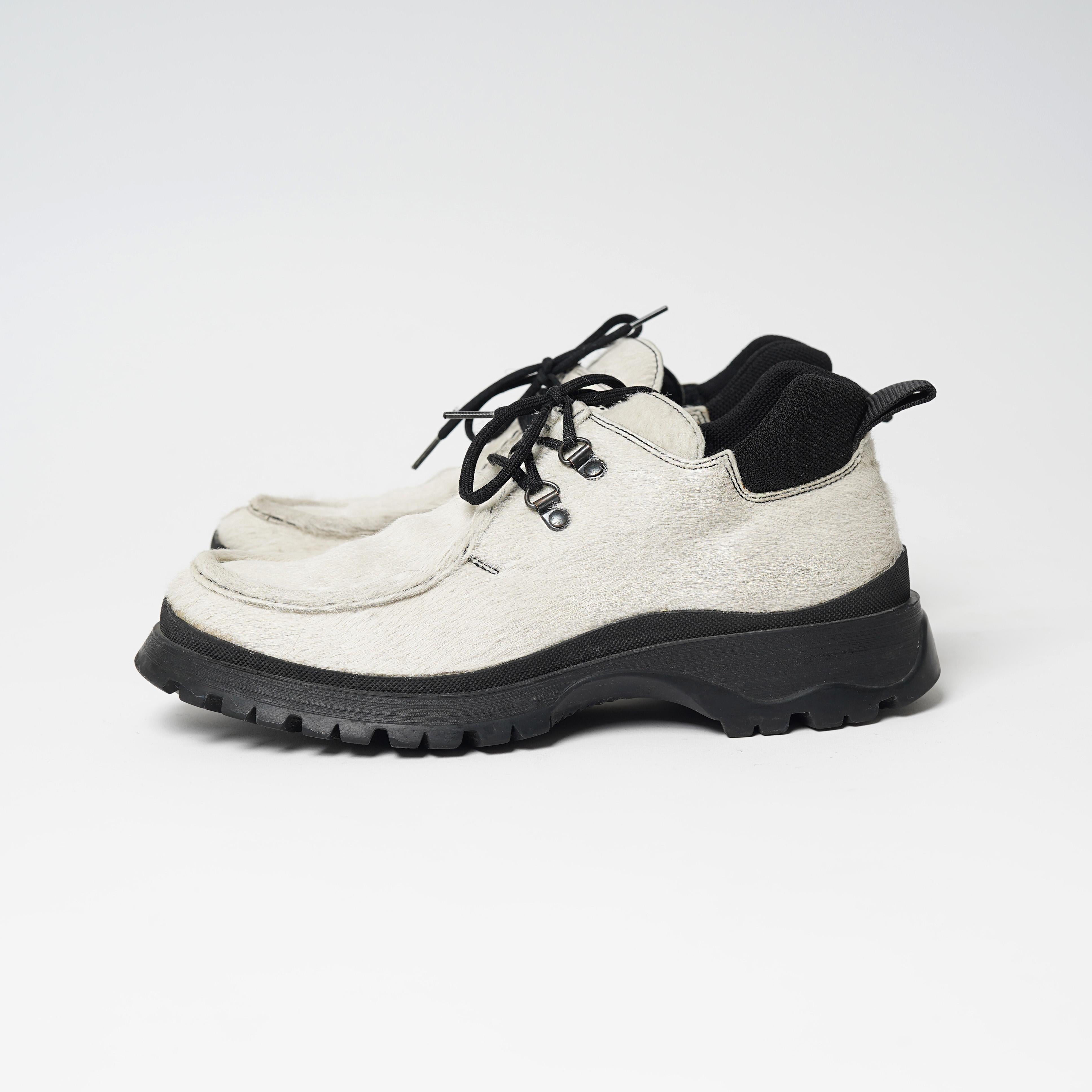 Presenting a pair of F/W 1998 Prada Sport White Pony Hair Chunky Rubber Sole Shoes. In a visionary move, Prada launched the house’s first-ever sportswear line in 1998. Prada Sport introduced the world to – in the brand’s own words — “metropolitan