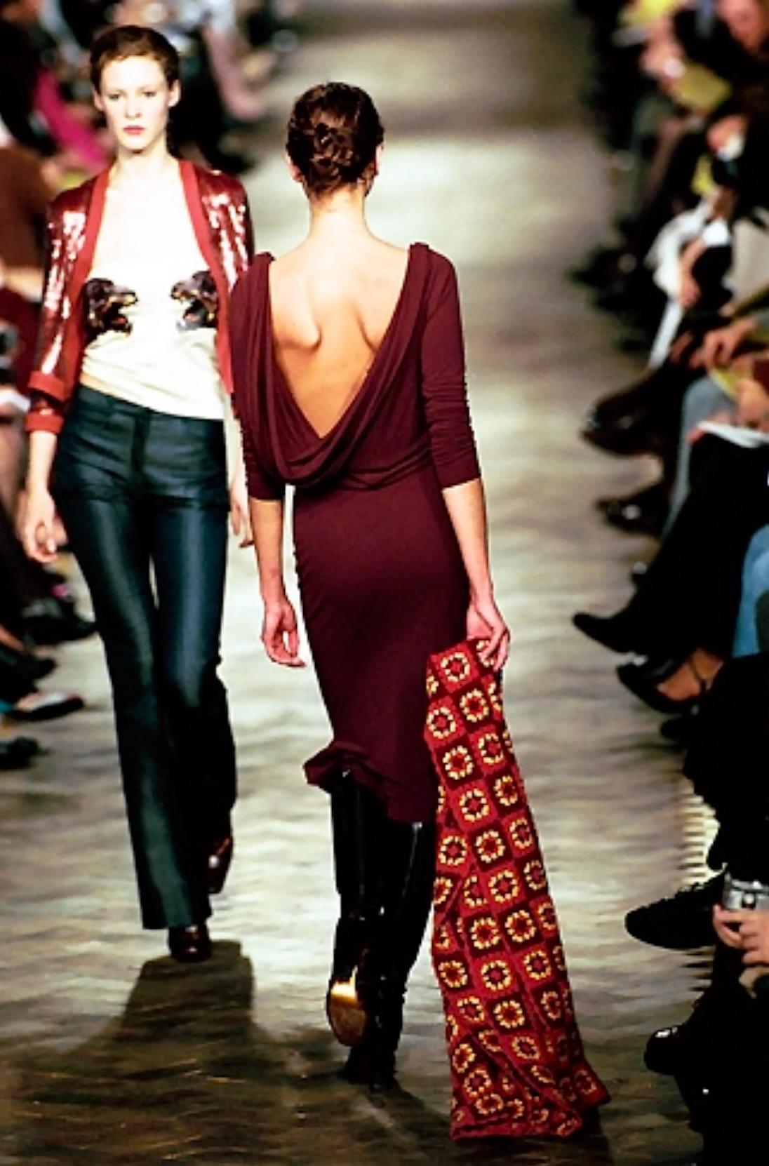 This Fall/Winter 1999 Chloé by Stella McCartney maroon bodycon  dress  features a draped cowl neckline that mirrors the dramatic open back, connected by a delicate strap. Debuting on the season's runway, this dress hugs the figure, while the subtle