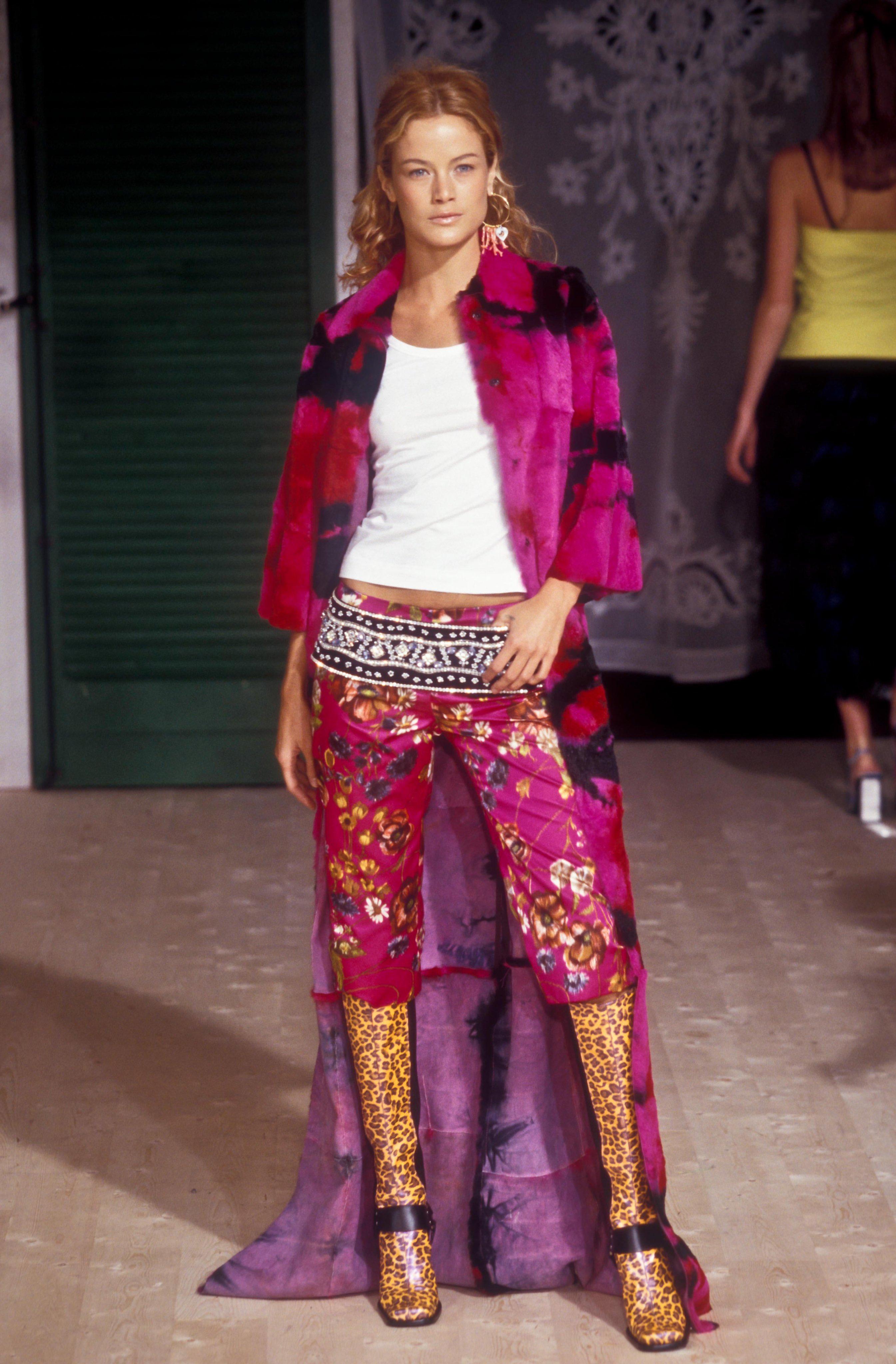 From the Fall/Winter 1999 collection, this pink tie-dye shoulder bag is constructed of shearling that perfectly matches garments displayed on the season's runway. This furry shoulder bag features hues of pink and red, complimented by a dark brown